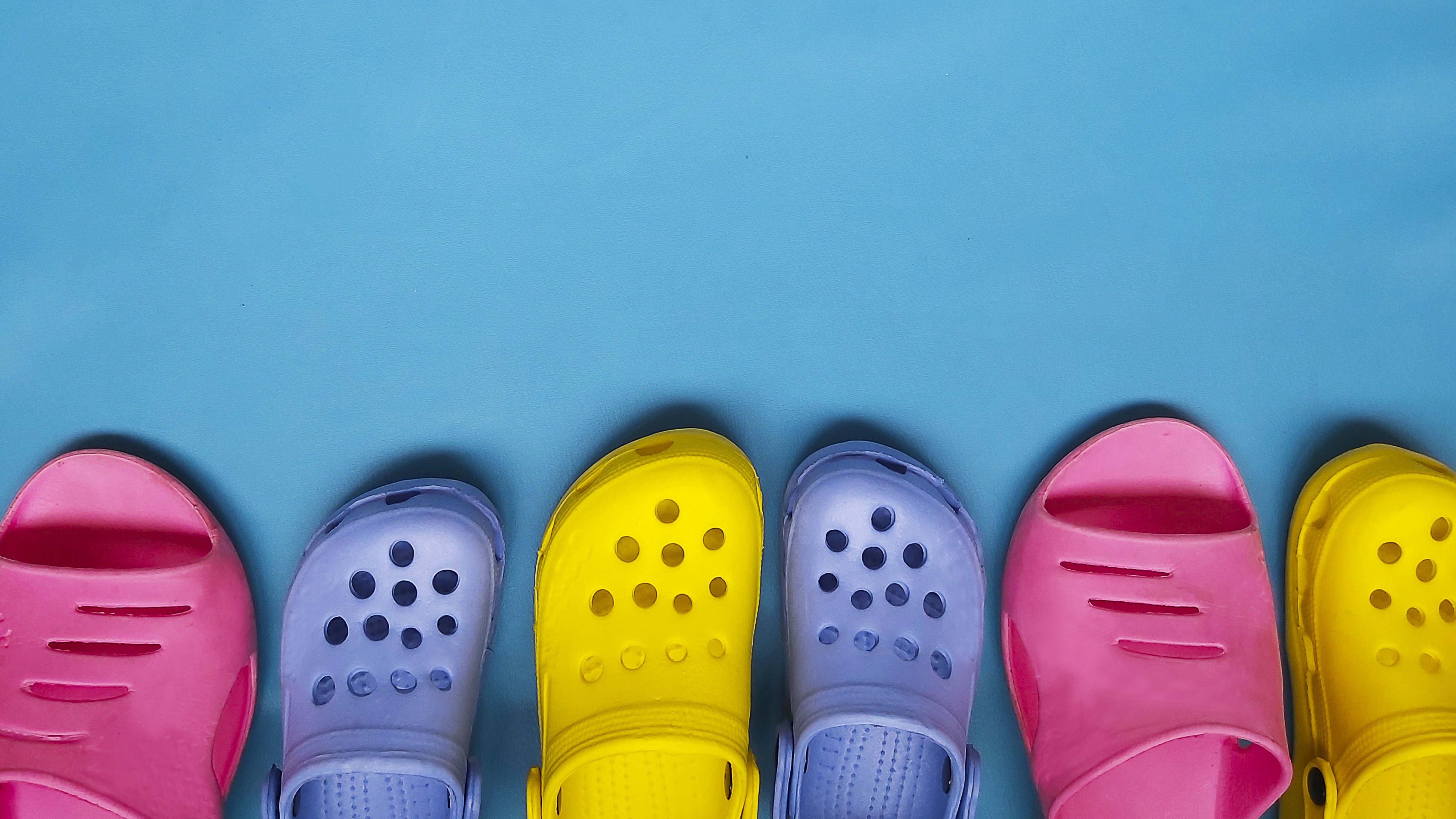 A lineup of colorful pairs of Crocs | Source: Getty Images