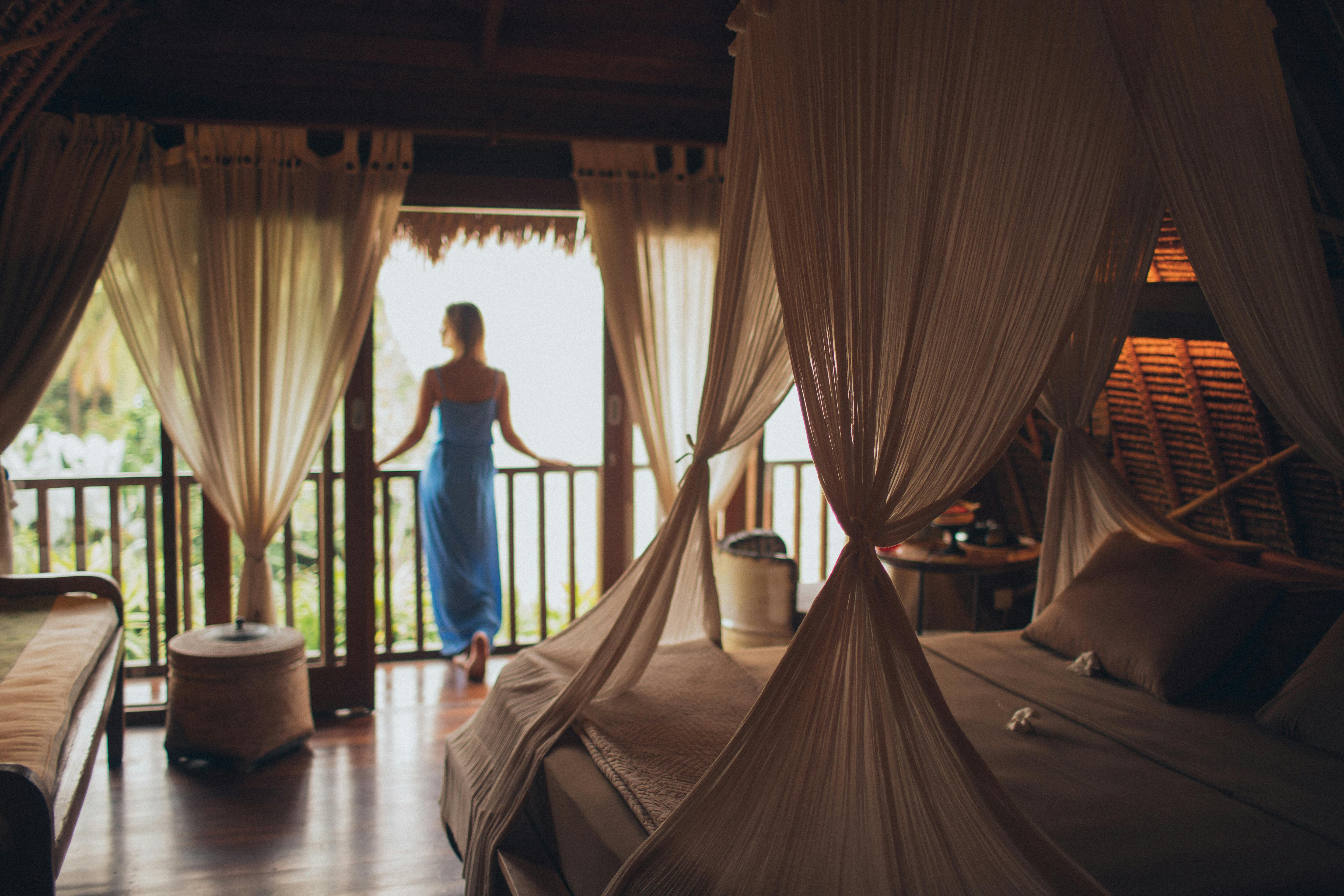Woman leaning on handrail in a hotel room | Source: Pexels