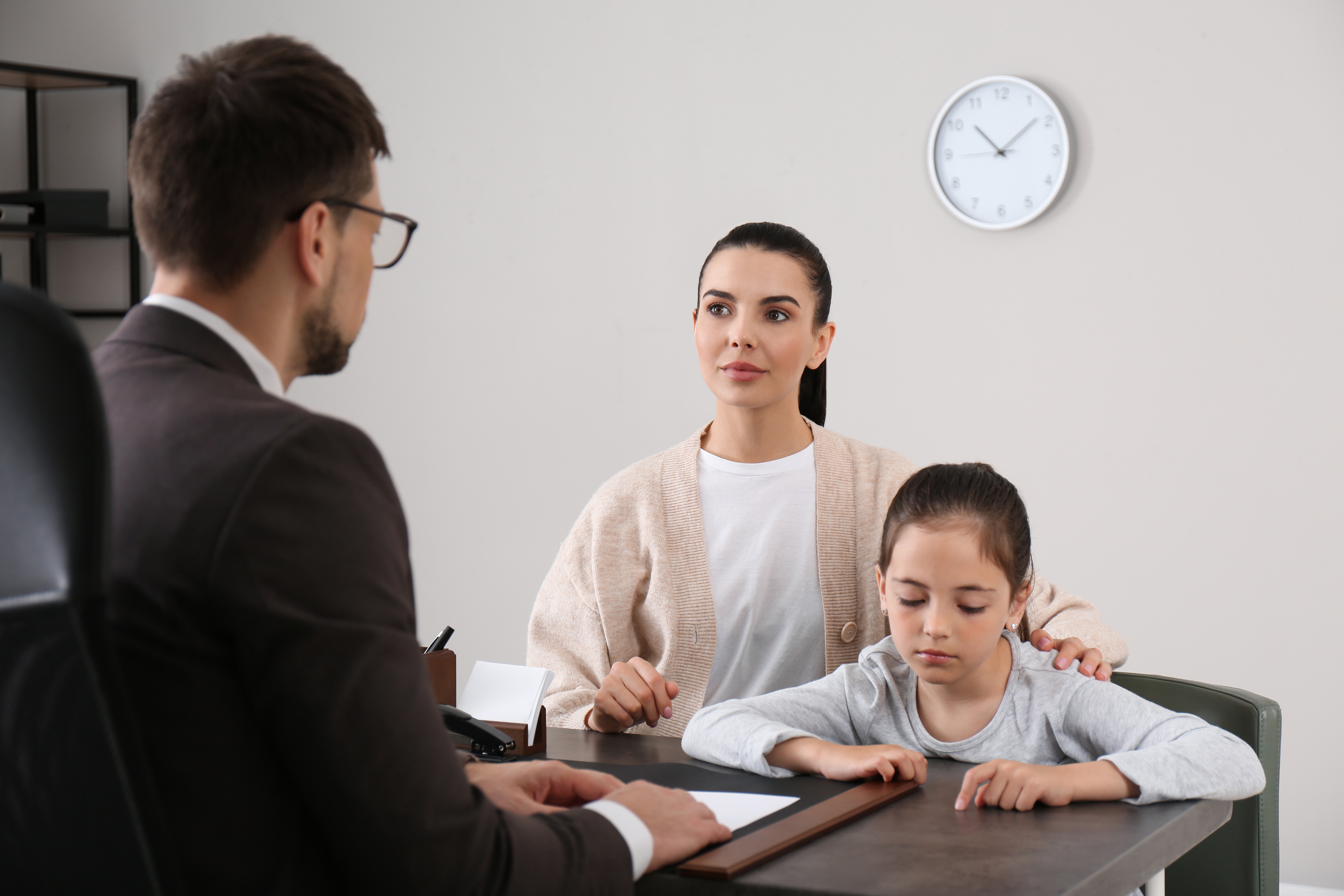 A mother and daughter having a meeting with the school principal | Source: Shutterstock