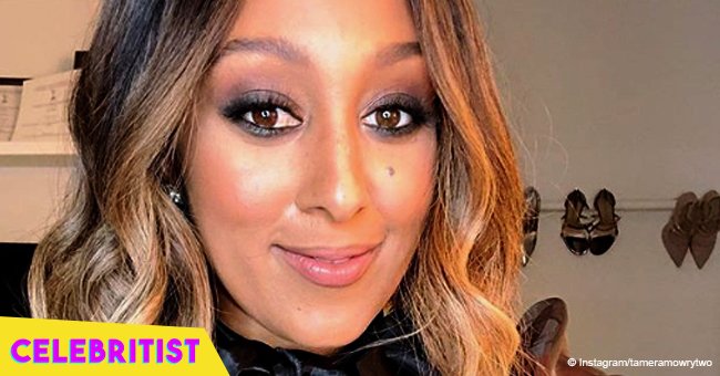 Tamera Mowry stuns in denim dress & thigh-high boots after being dragged for having 'an attitude'