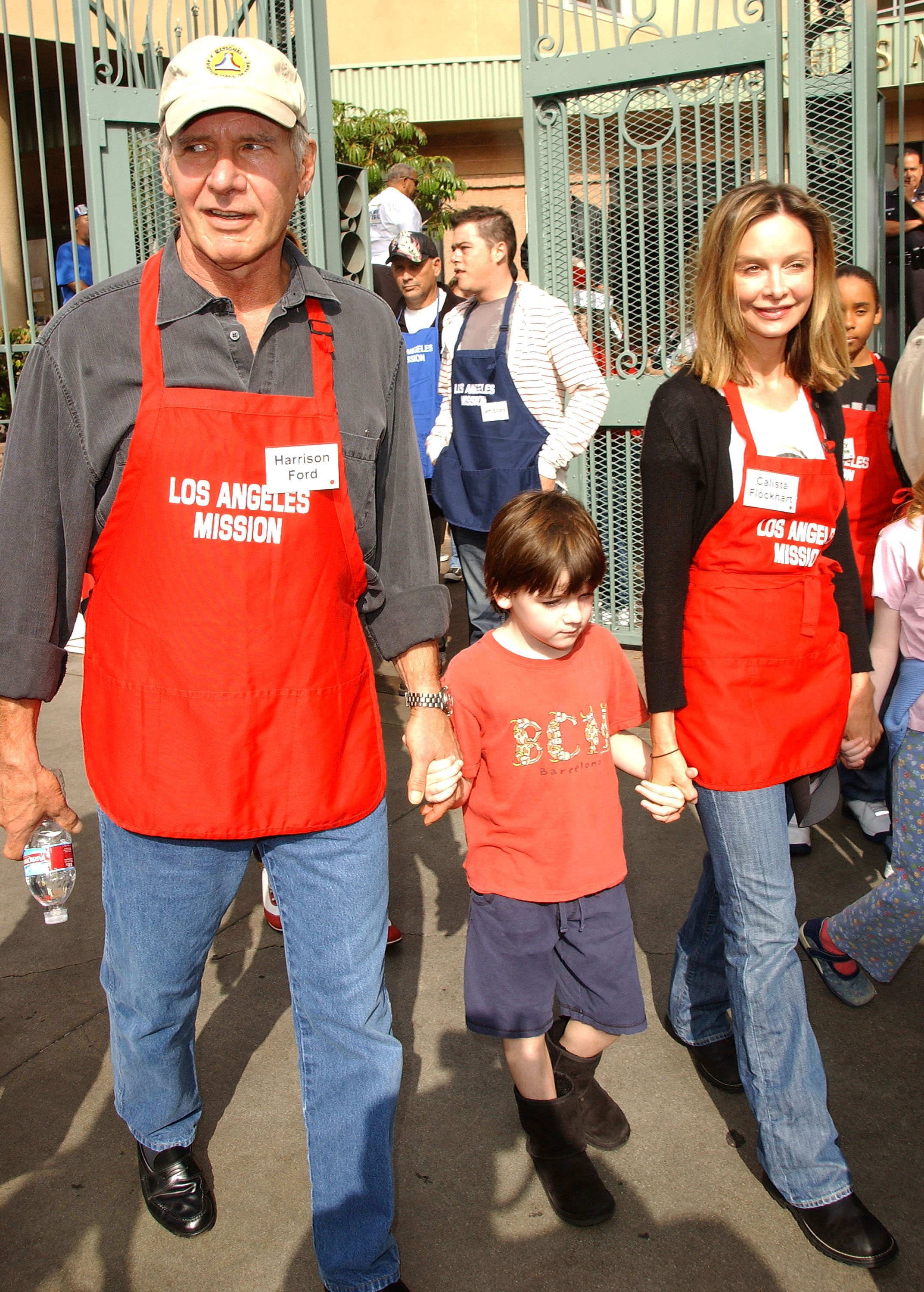 Harrison Ford and Liam and Calista Flockhart serving Thanksgiving dinner to the Skid Row homeless on November 21, 2007, in Downtown Los Angeles, California. | Source: Getty Images