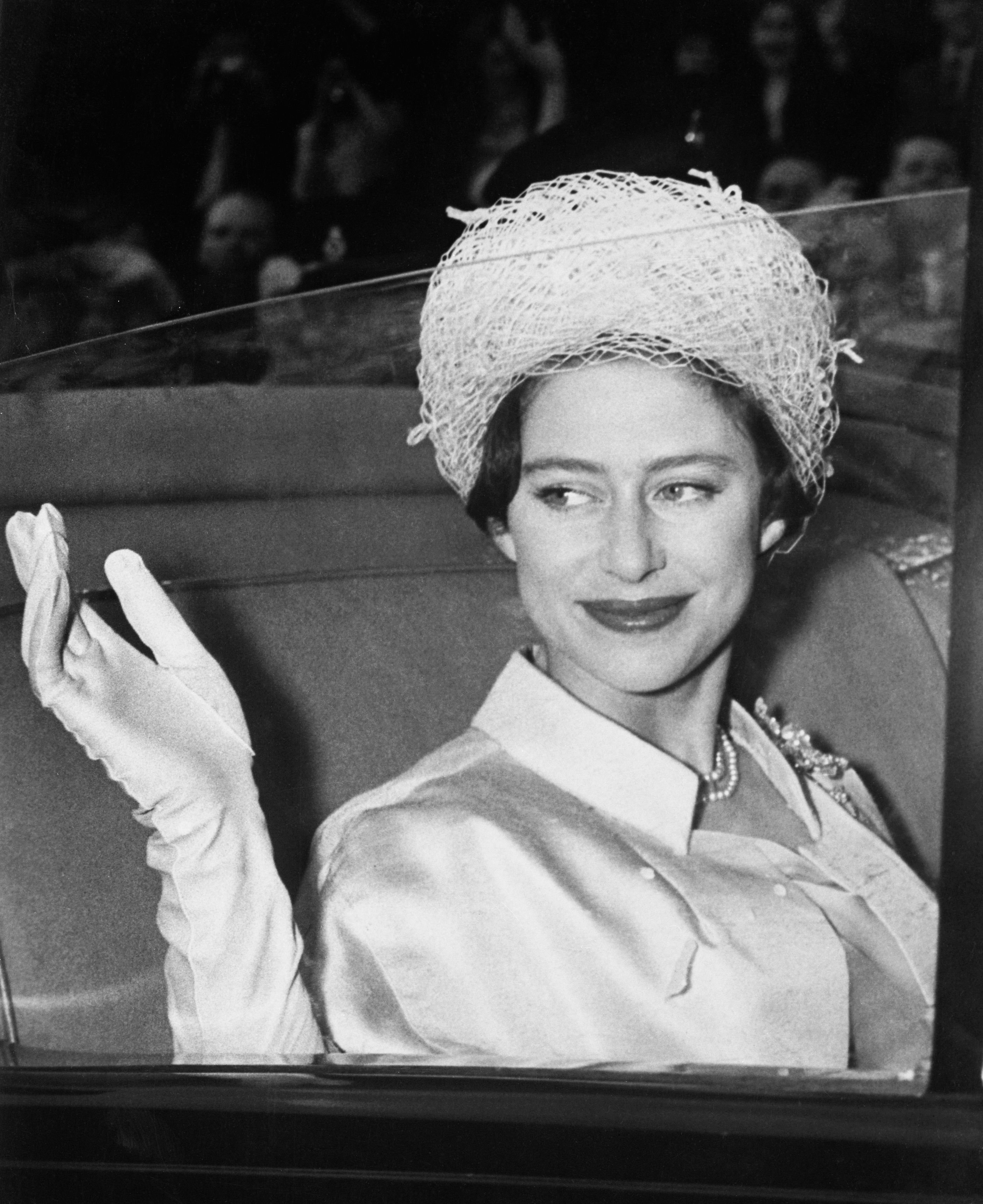 Princess Margaret waves from her vehicle at Buckingham Palace, headed for her honeymoon with Antony Armstrong-Jones. | Source: Getty Images