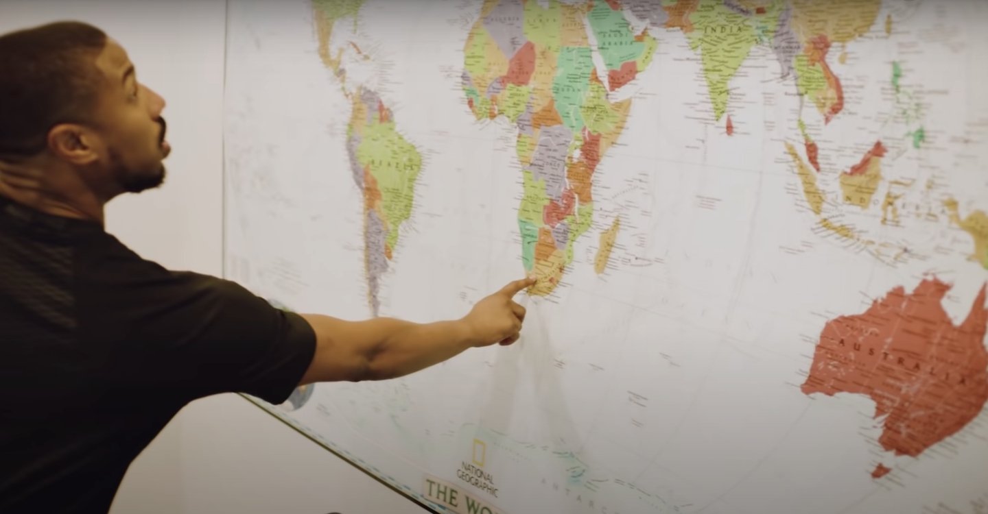 Film producer Michael B. Jordan showing Vogue Magazine one of his favorite places on the world map placed the lounge area wall. | Source: YouTube/Vogue