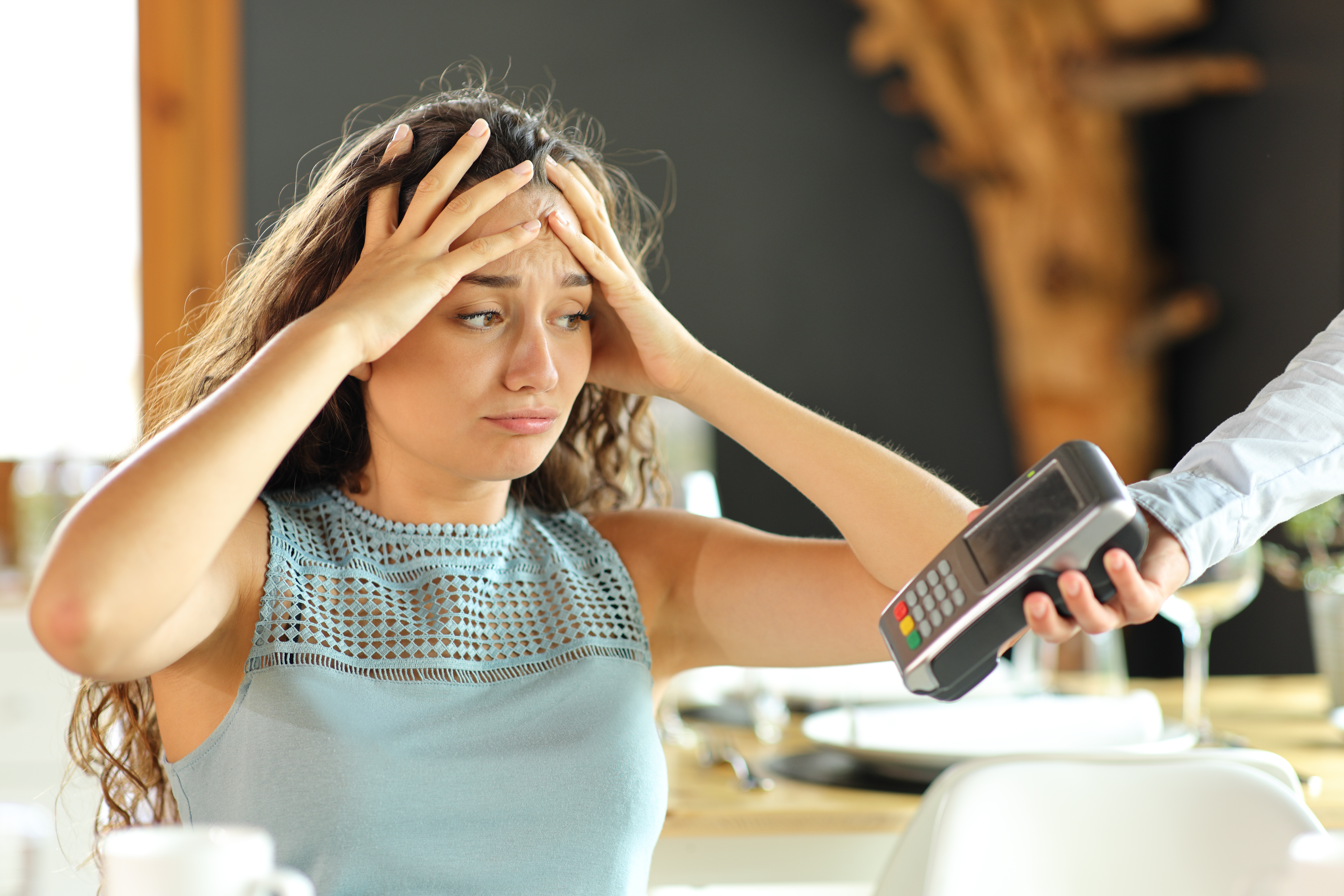 A woman complains about expensive restaurant bill | Source: Shutterstock