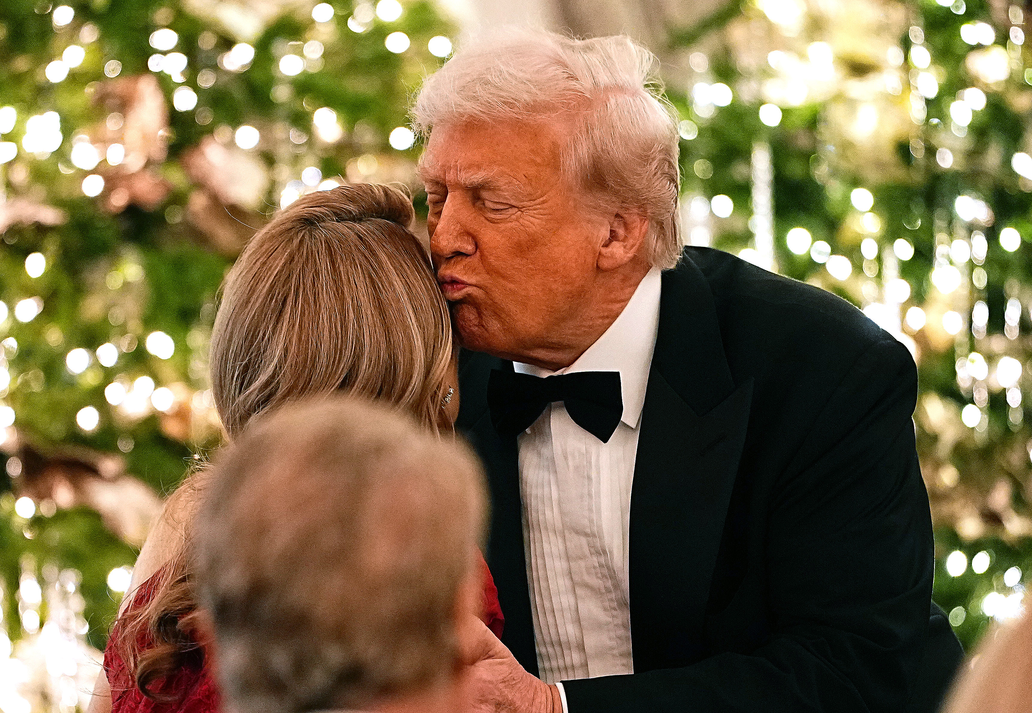U.S. President Donald Trump greets a guest before speaking at the State Department Kennedy Center Honors medal presentation dinner