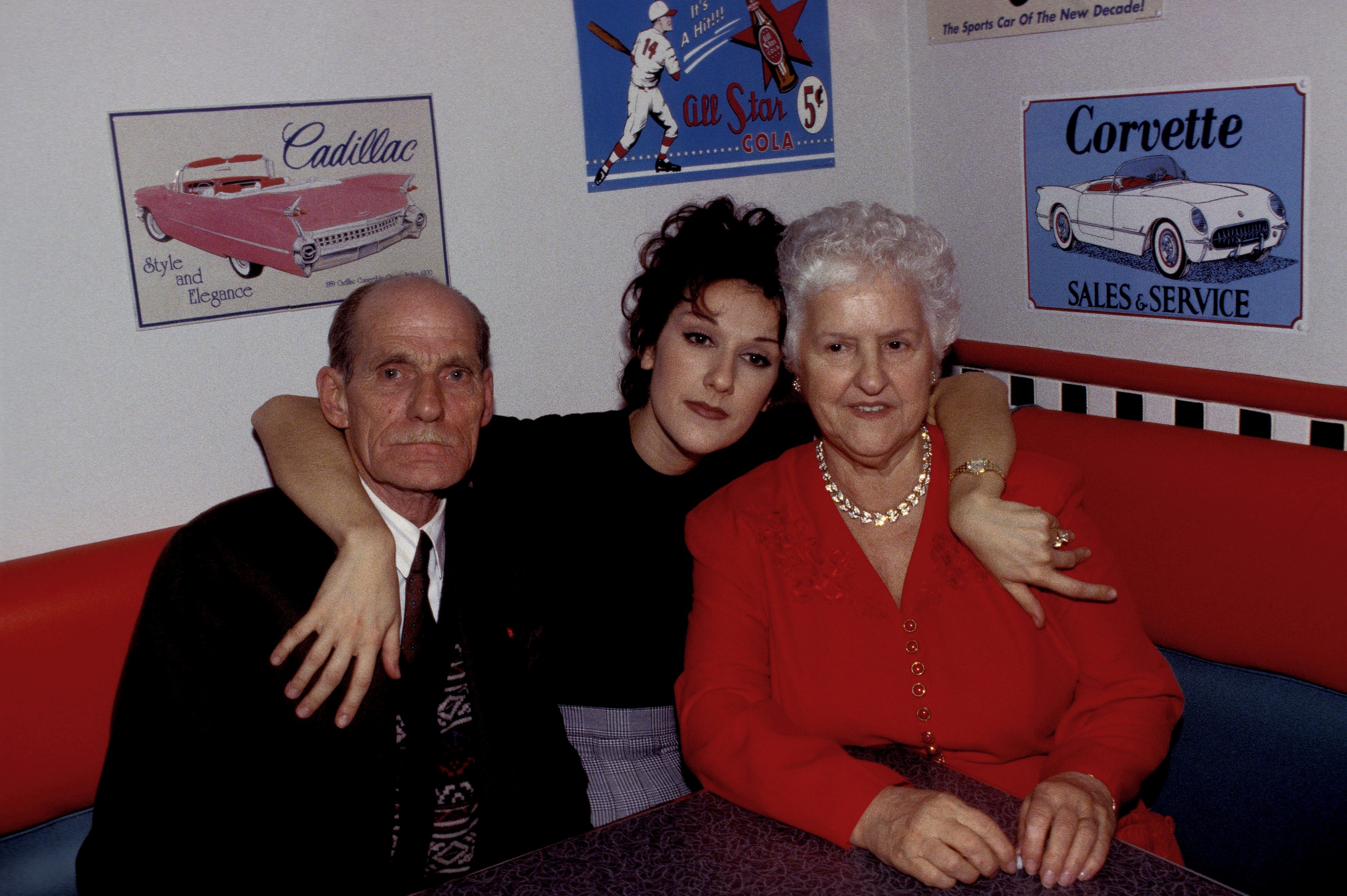 Celine Dion celebrates her 26th birthday with Thérèse Tanguay-Dion and Adhemar Dion in her restaurant "Nickel's" in Montreal, Canada, on March 7, 1994. | Source: Getty Images