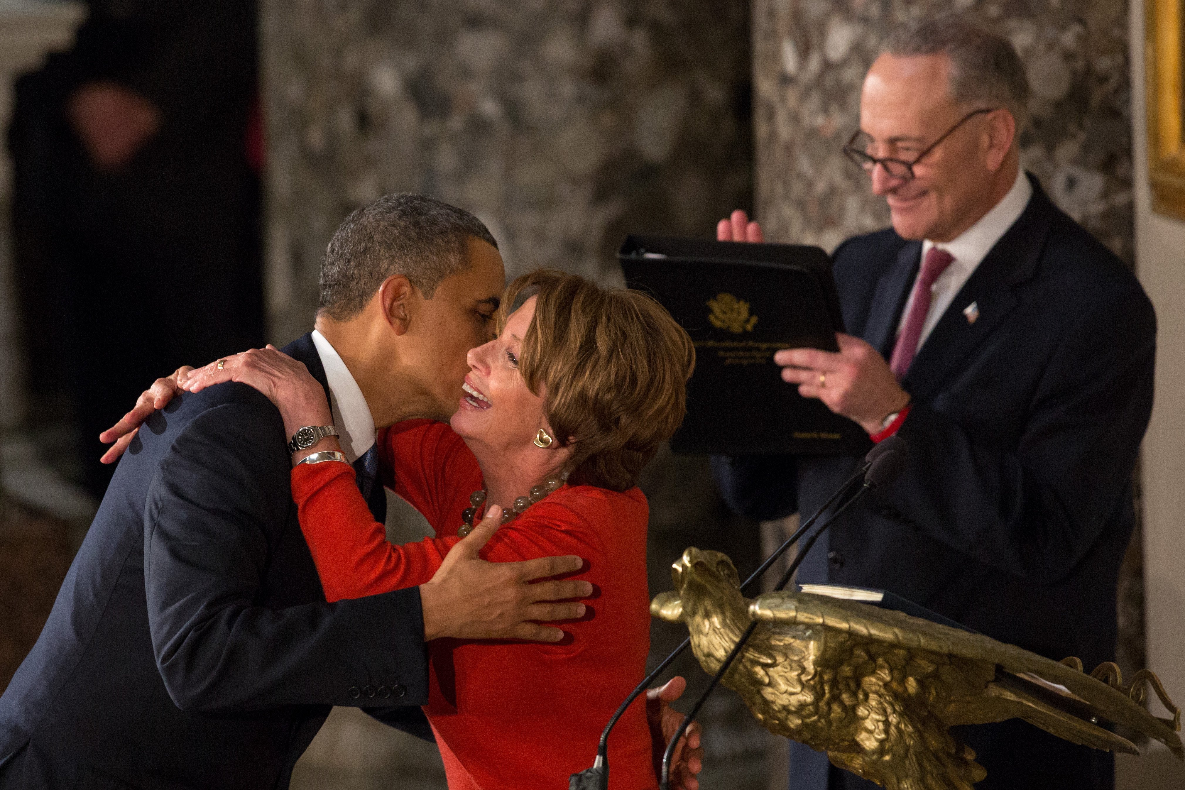 Barack Obama and Nancy Pelosi greeting each other at the Inaugural Luncheon in Statuary Hall in 2013 | Photo: Getty Images
