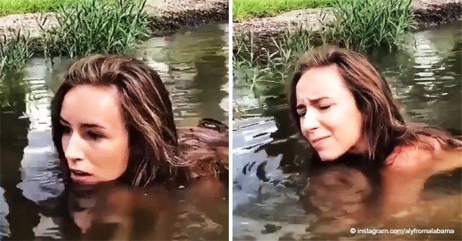 Girl squats in murky water, puts her hands to the bottom and pulls out a huge creature