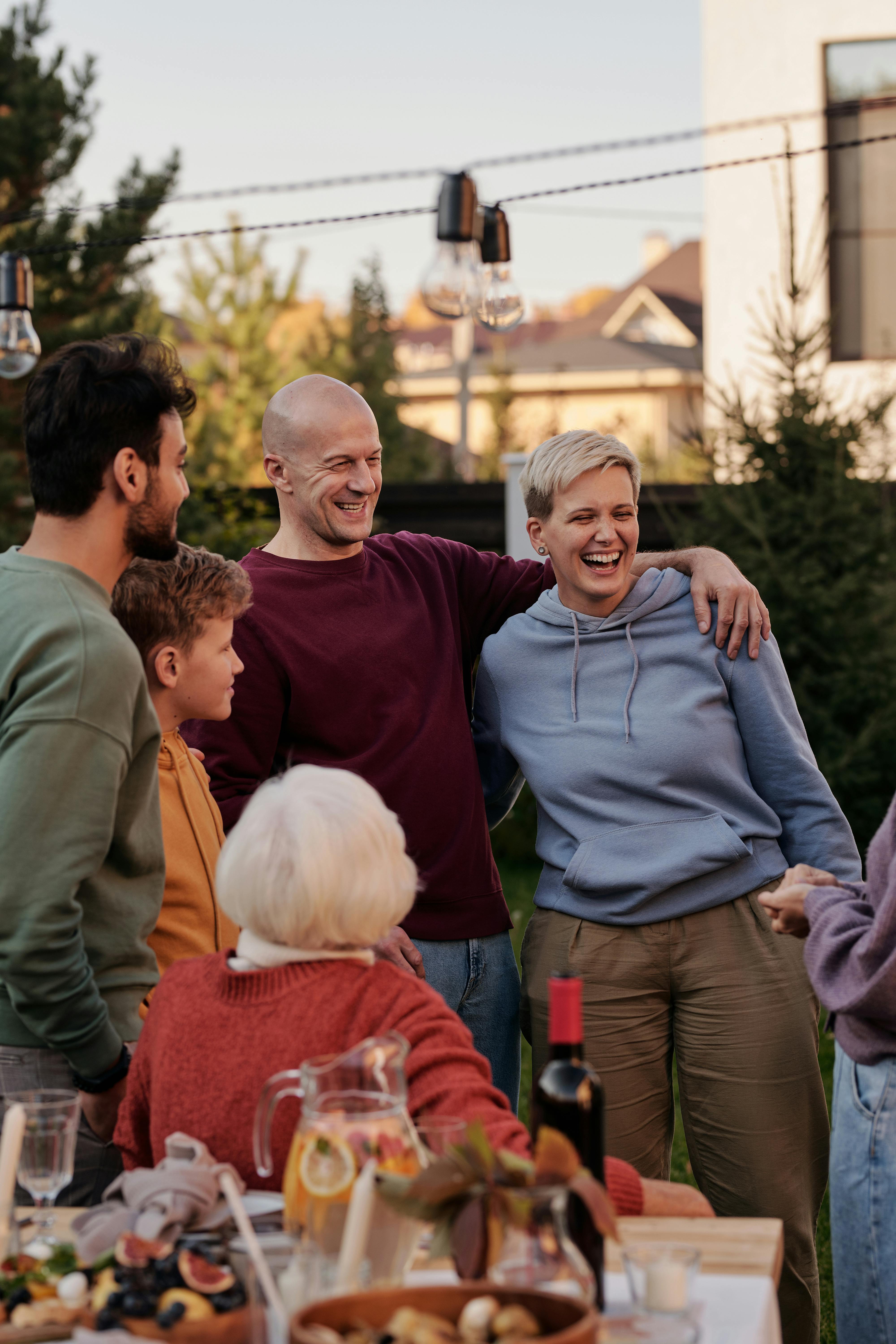 Smiling people in a family dinner | Source: Pexels