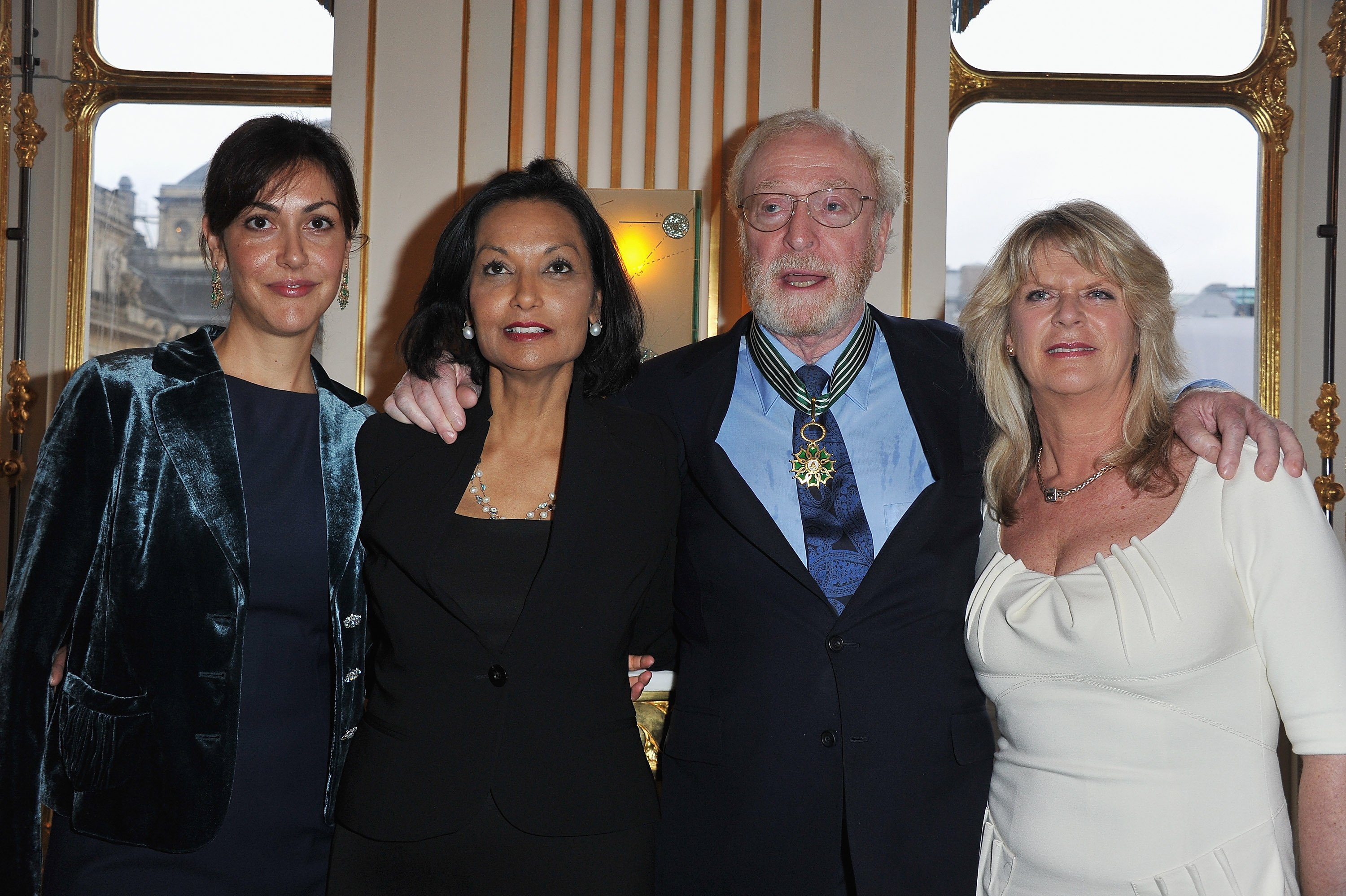 Actor Sir Michael Caine poses with daughters Natasha (L) and Dominique (R) and his wife Shakira (2ndL) after being awarded "Commandeur des arts et des lettres" by French Culture Minister Frederic Mitterrand at Ministere de la Culture on January 6, 2011 in Paris, France | Source: Getty Images 