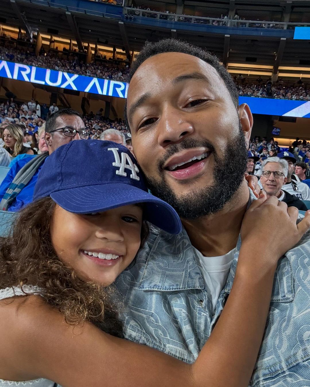 John Legend and Luna at the Dodgers and the Yankees pivotal Game 1 of the World Series, from a post dated October 26, 2024 | Source: Instagram/johnlegend/