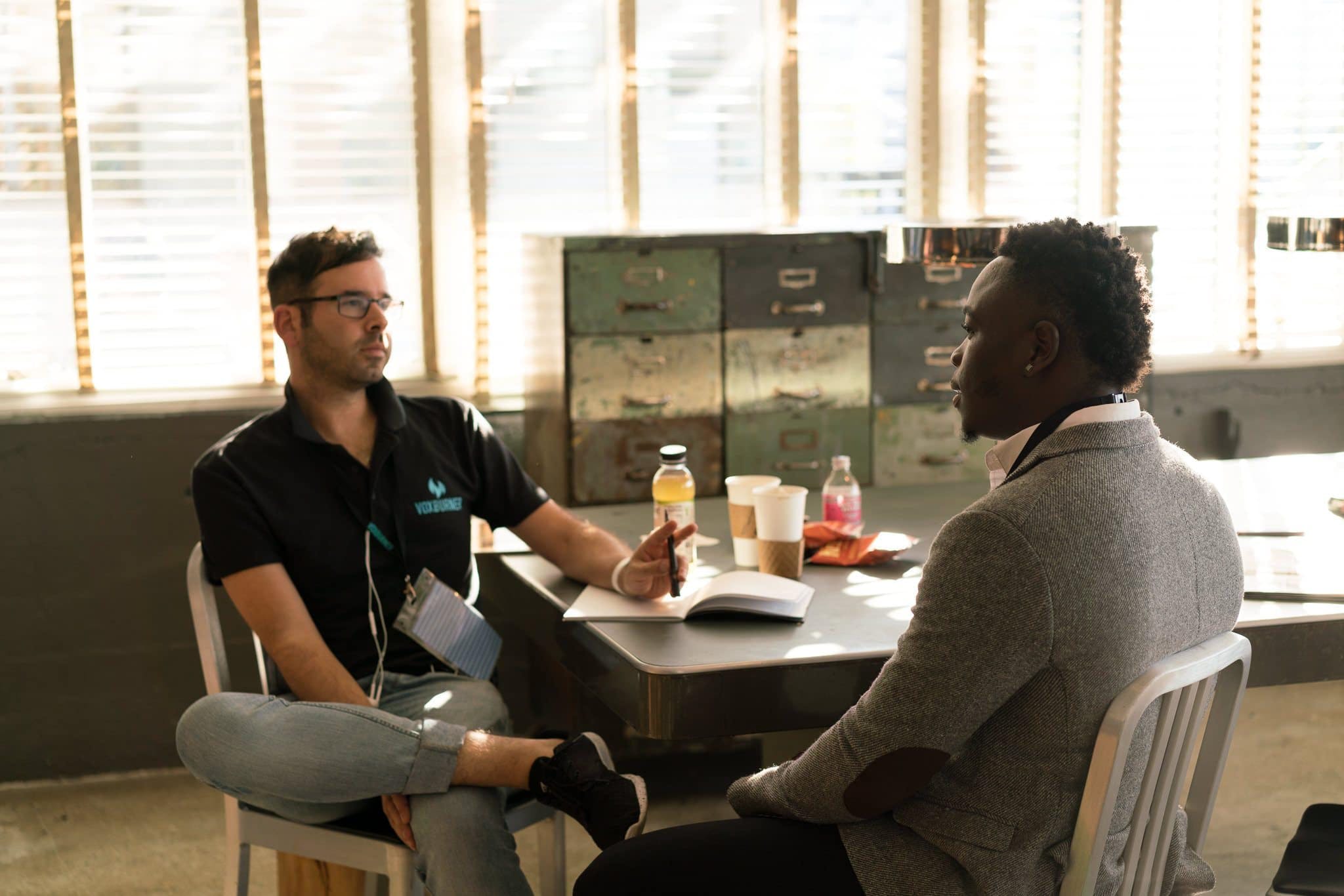 Two men having a conversation. | Source: Pexels