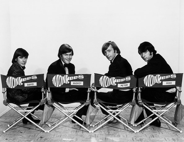 The Monkees members smiling while seated head over shoulder, undated picture. | Photo: Getty Images