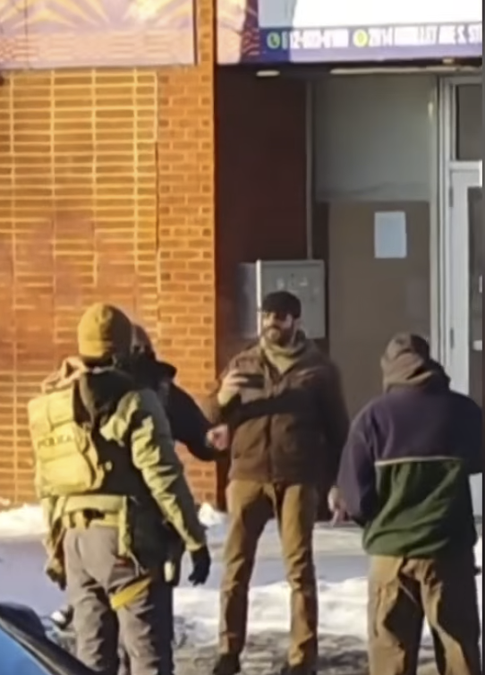 Alex Pretti seen holding a mobile phone while filming from a video posted on January 25, 2026 |  Source: YouTube/@fox9