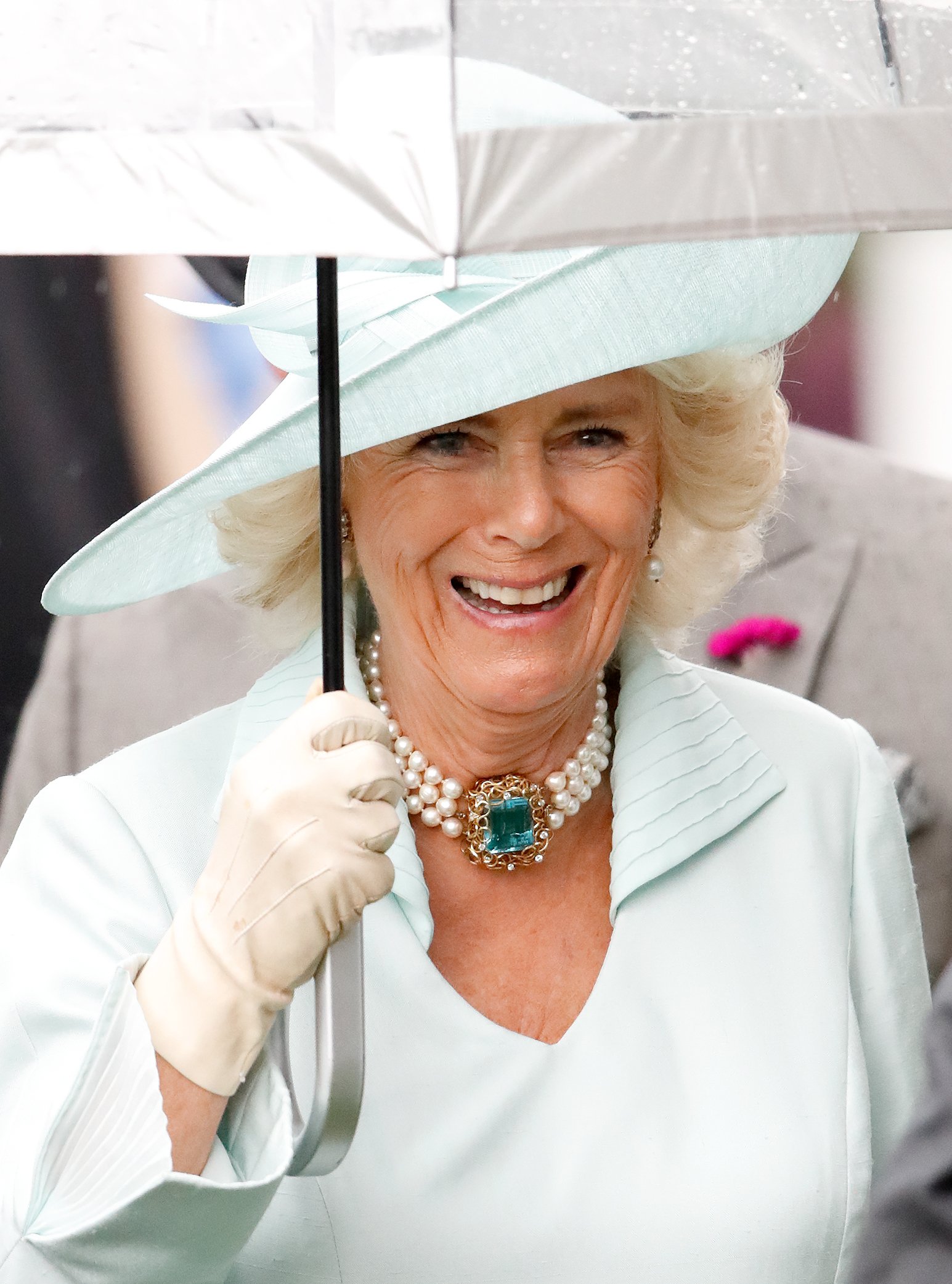 Camilla, Duchess of Cornwall, covers herself with an umbrella as she attends day two of Royal Ascot at Ascot Racecourse on June 19, 2019, in Ascot, England. | Source: Getty Images