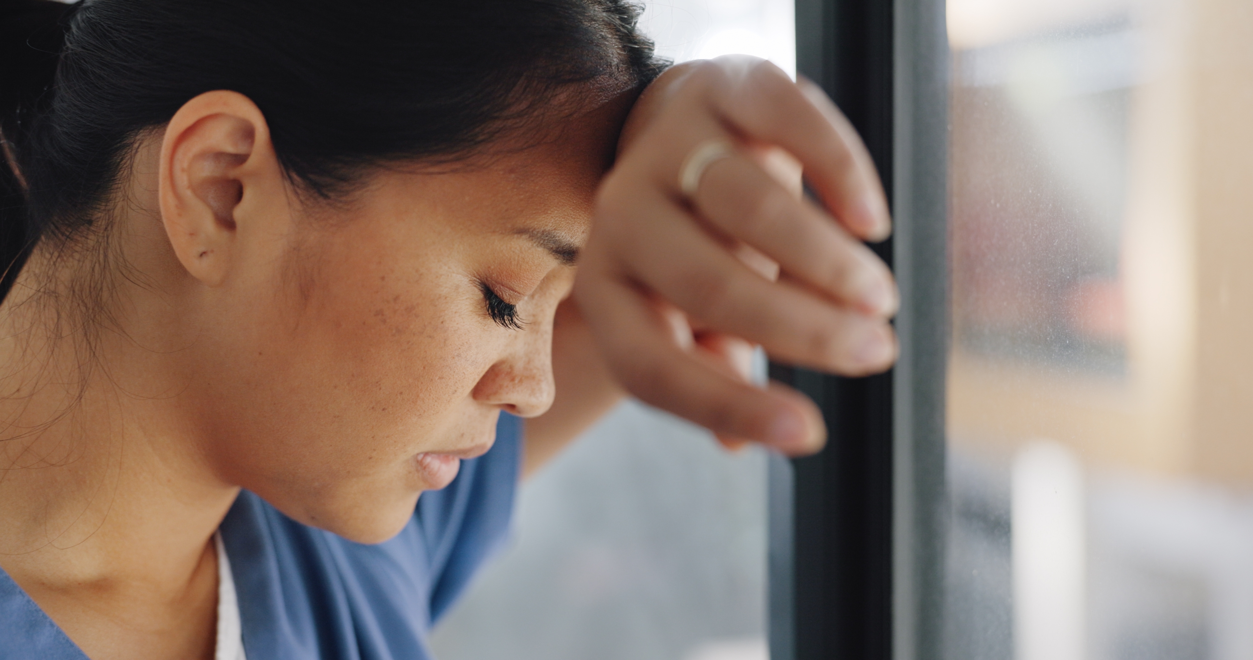 A dejected nurse talking a breather | Source: Shutterstock