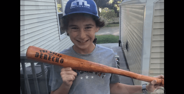 Tommy Rhomberg holding the first bat he made | Photo: YouTube/CBS Evening News