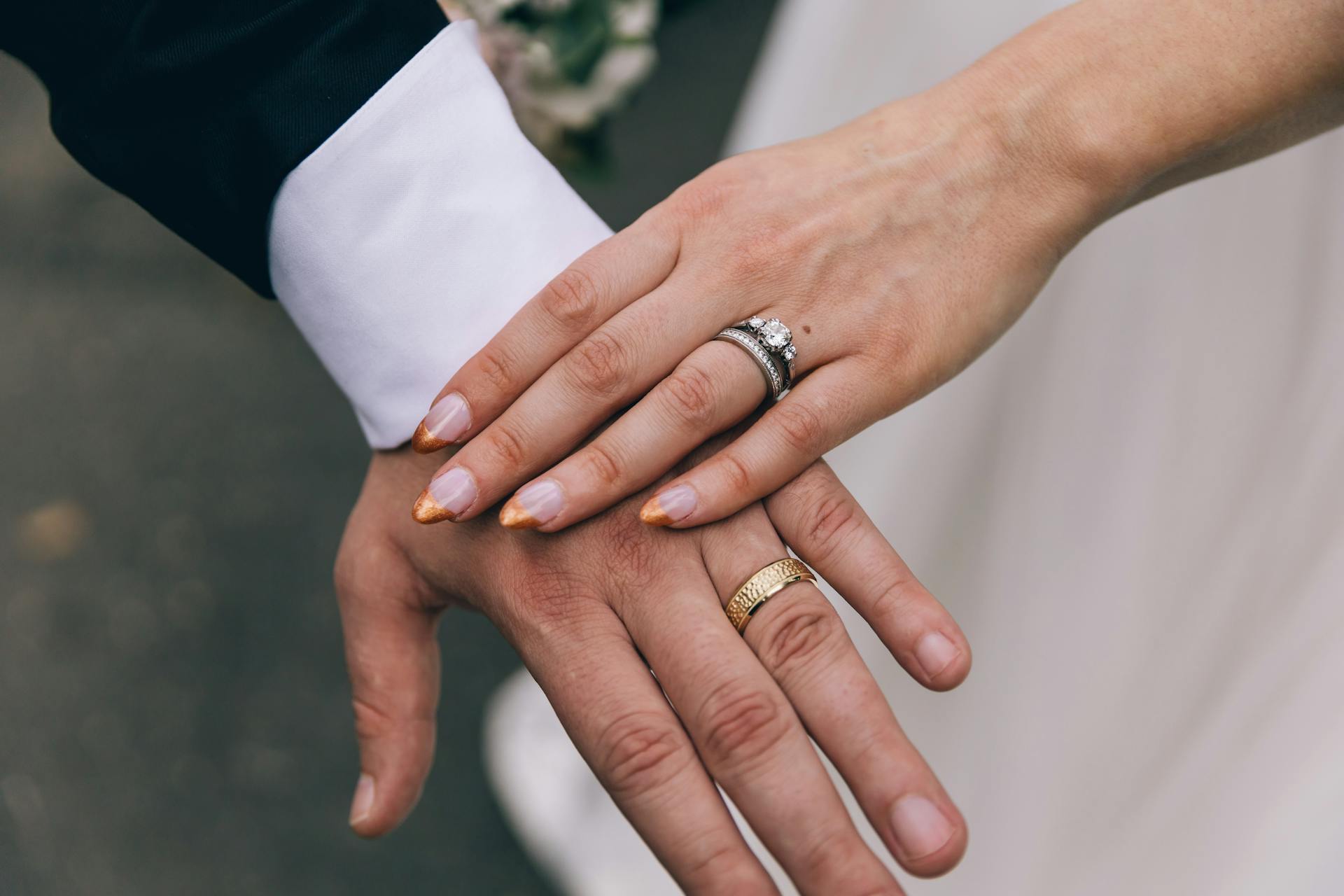 A couple showing their wedding rings | Source: Pexels