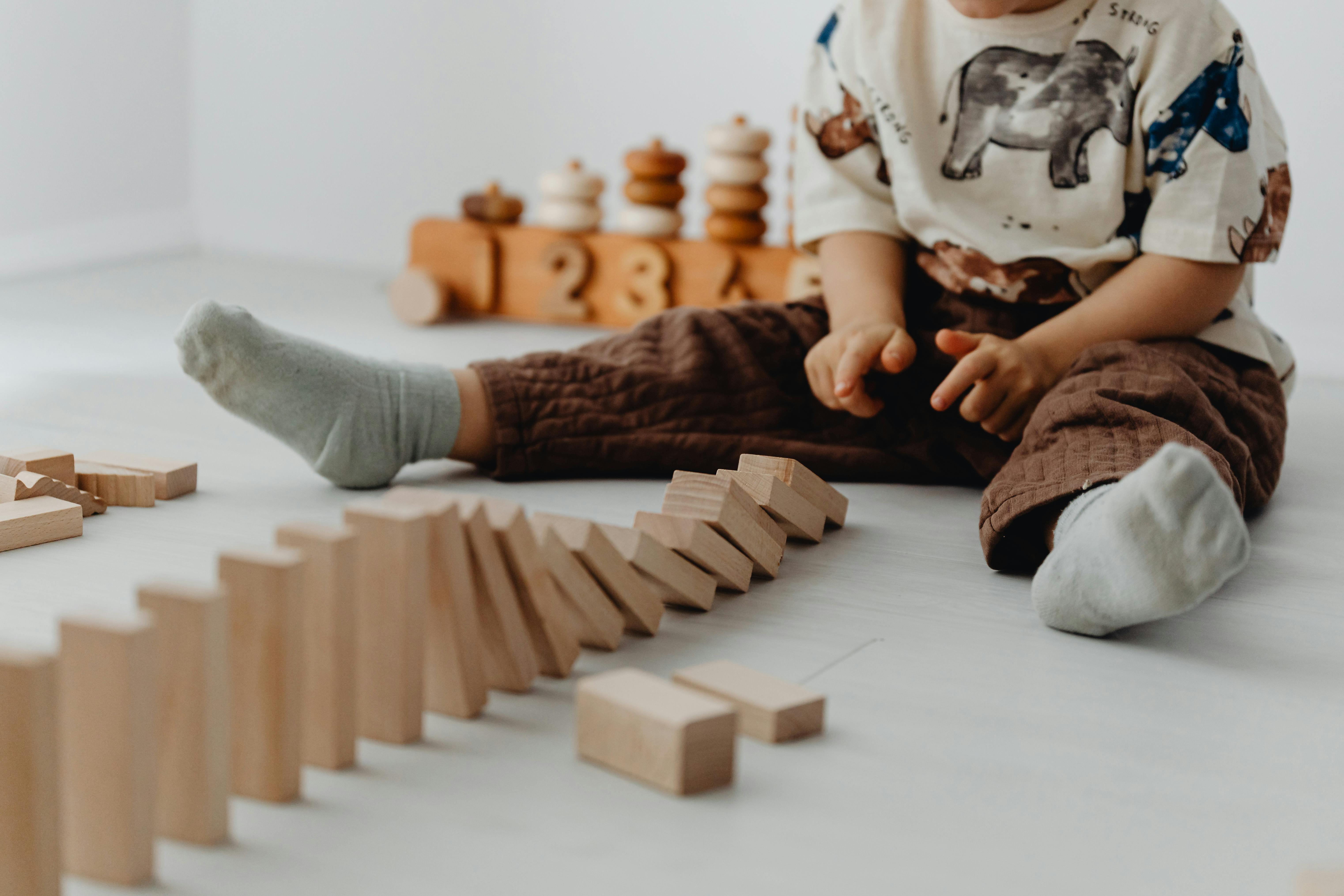 A baby playing with wooden toys | Source: Pexels