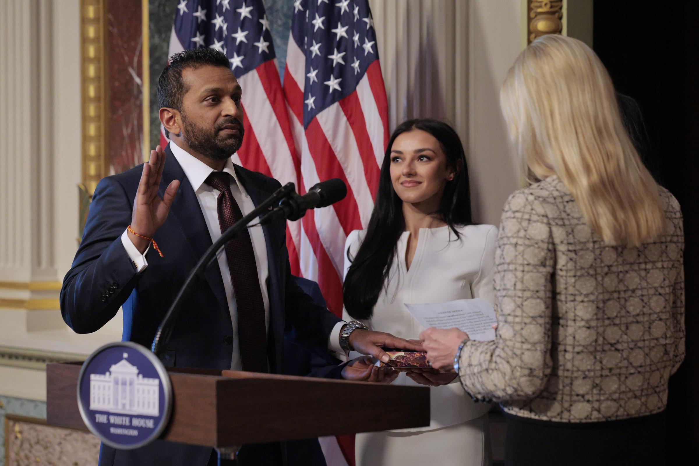 Attorney General Pam Bondi swearing in the new Federal Bureau of Investigation Director Kash Patel as his girlfriend, Alexis Wilkins, holds the Bhagavad Gita in the Indian Treaty Room in the Eisenhower Executive Office Building on February 21, 2025 in Washington, D.C. | Source: Getty Images