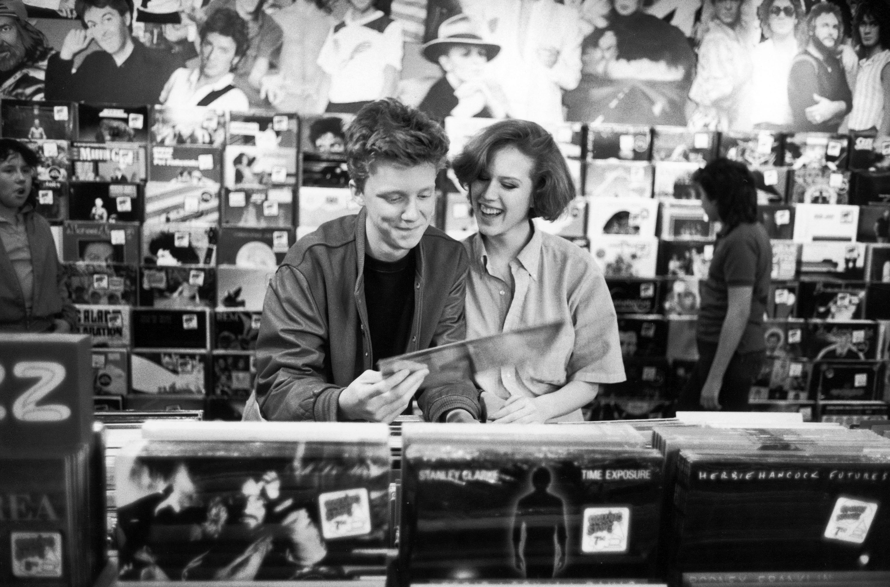 Actors Anthony Michael Hall and Molly Ringwald browsing in record shop during break in location shooting of The Breakfast Club. | Source: Getty Images