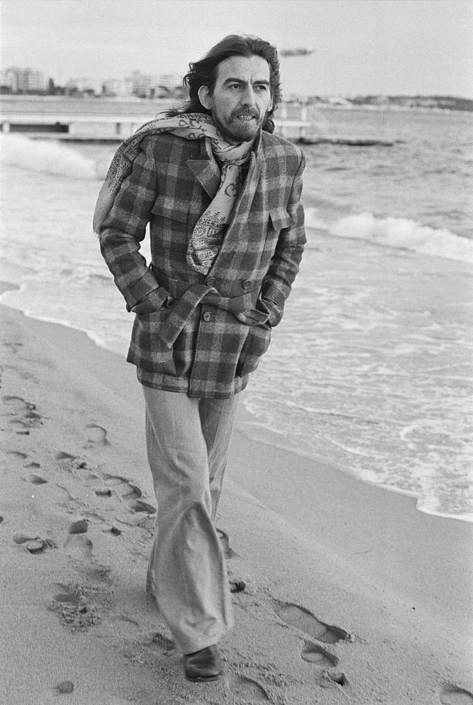 English singer-songwriter, guitarist and former Beatle, George Harrison (1943 - 2001) on the beach in Cannes, France | Getty Images / Global Images Ukraine English singer-songwriter, guitarist and former Beatle, George Harrison (1943 - 2001) on the beach in Cannes, France | Getty Images / Global Images Ukraine