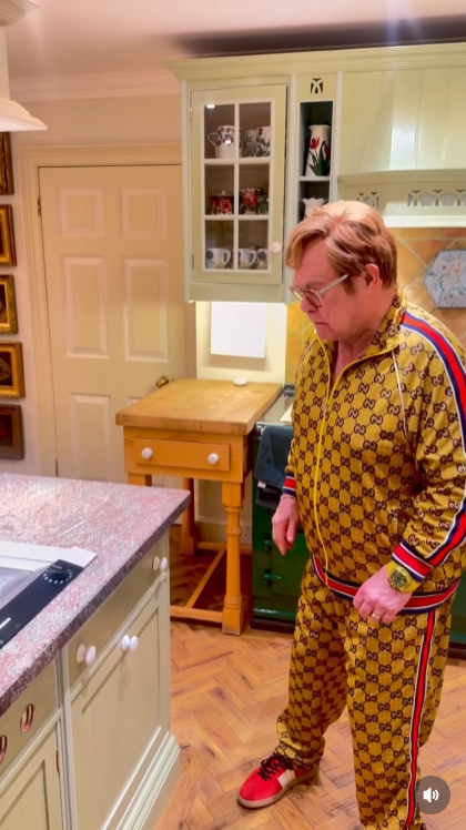 After yet another drawer erupts into "Step Into Christmas," John stands frozen in disbelief — the look of a man realising his entire kitchen may be possessed by his own holiday hit. | Source: Instagram/eltonjohn