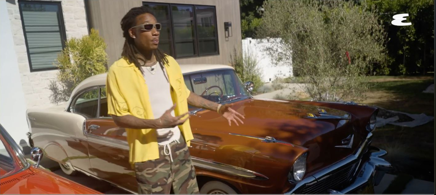 Wiz Khalifa stands beside his 1956 Chevrolet Bel Air while discussing the oldest vehicle in his collection during an Esquire garage tour video published on July 29, 2022. | Source: YouTube/Esquire