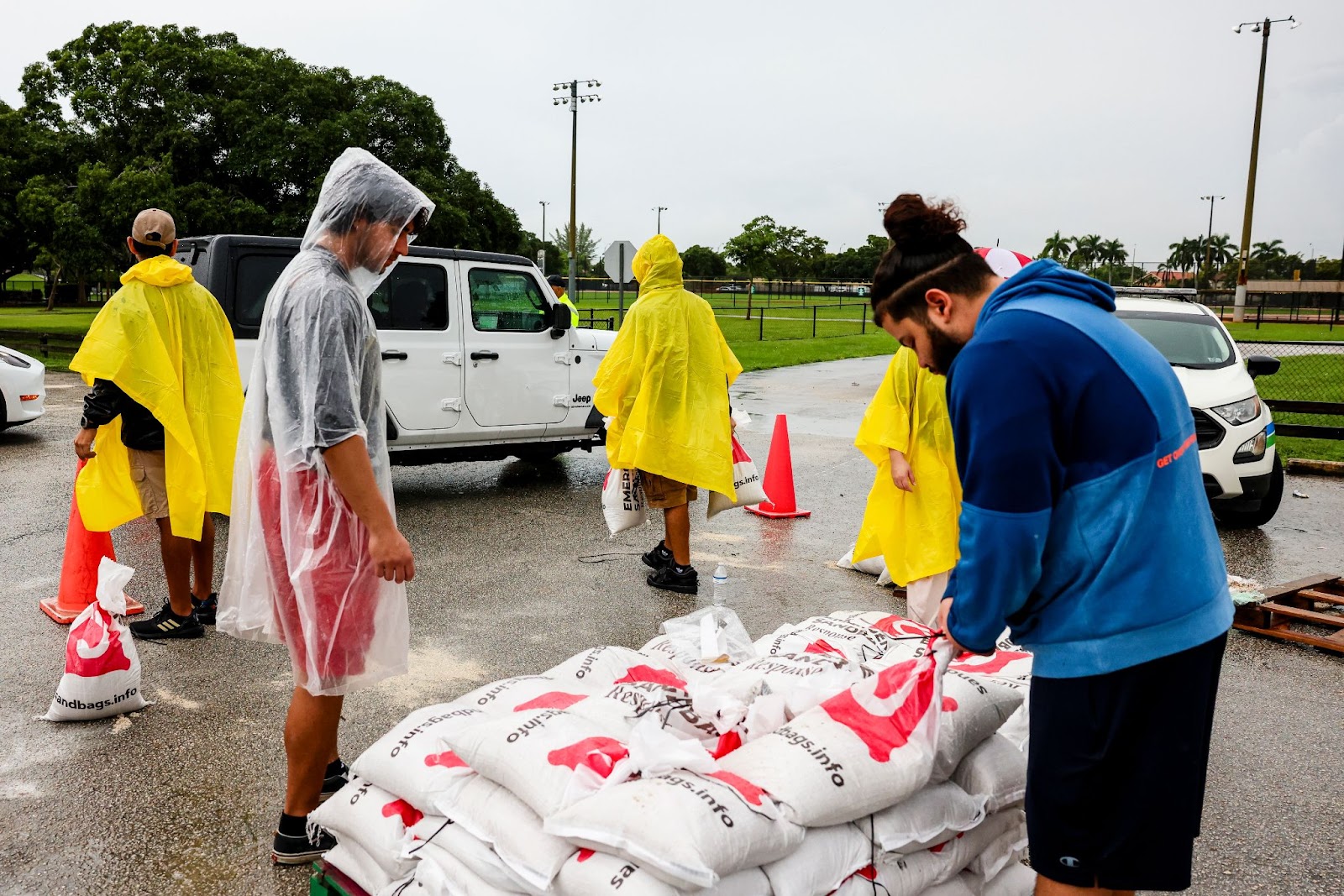 Municipal workers handling sandbags to ward off flooding ahead of Hurricane Milton in Miami, Florida. | Source: Getty Images