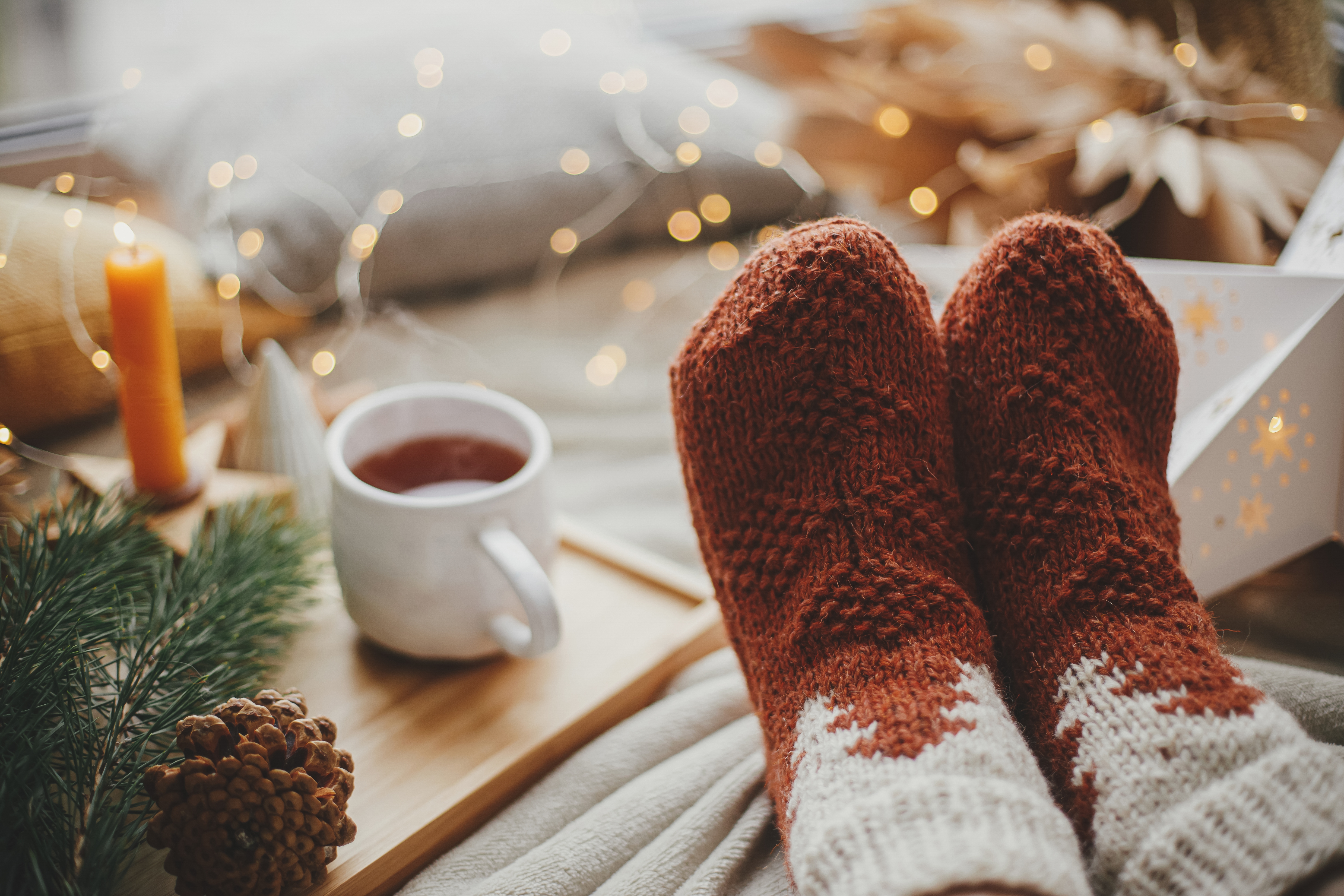 A person wearing cozy socks with tea | Source: Shutterstock