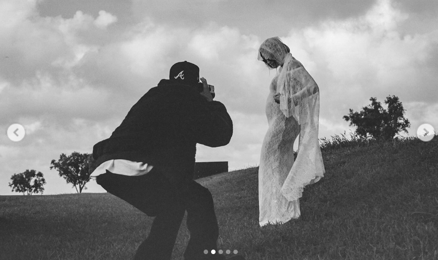 Justin Bieber crouches down as he takes a picture of his pregnant wife, Hailey, from a video post dated May 9, 2024 | Source: Instagram/haileybieber