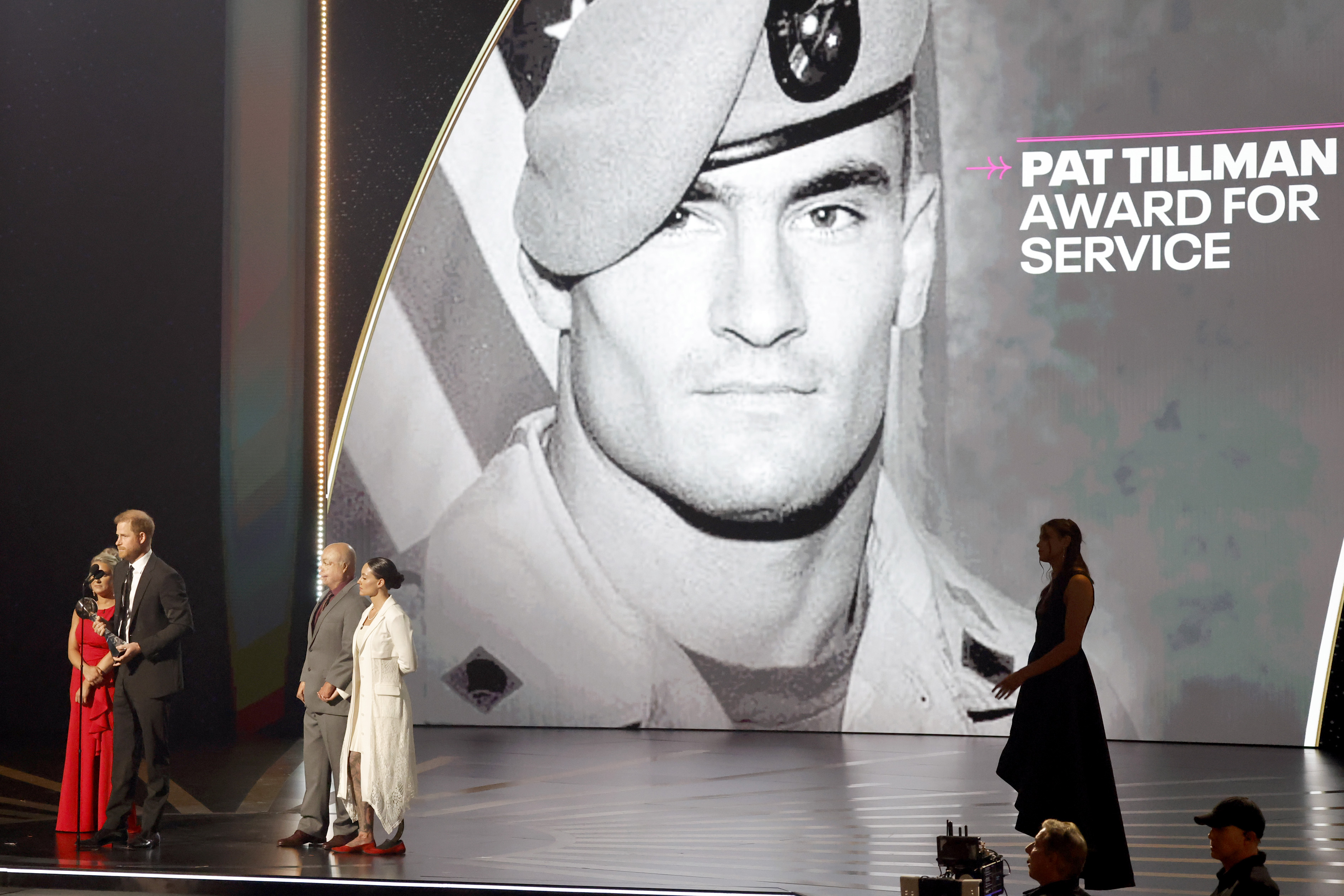 Prince Harry on stage accepting the Pat Tillman Award from Kirstie Ennis, Israel Del Toro, and Elizabeth Marks during the ESPY Awards on July 11, 2024 in Hollywood, California | Source: Getty Images