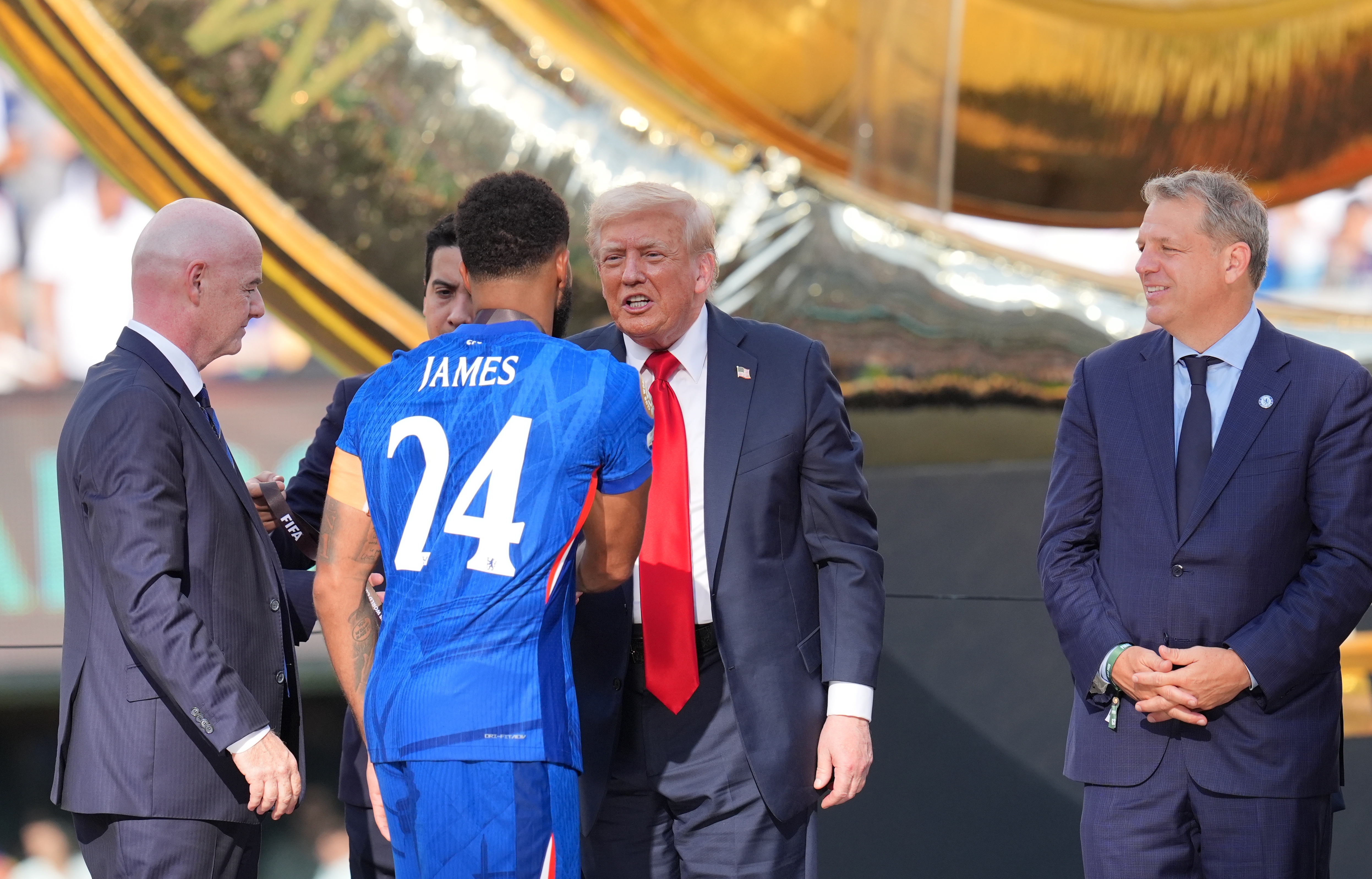 Donald Trump presenting a medal to Chelsea captain Reece James following the FIFA Club World Cup 2025 final match on July 13 in New Jersey. | Source: Getty Images