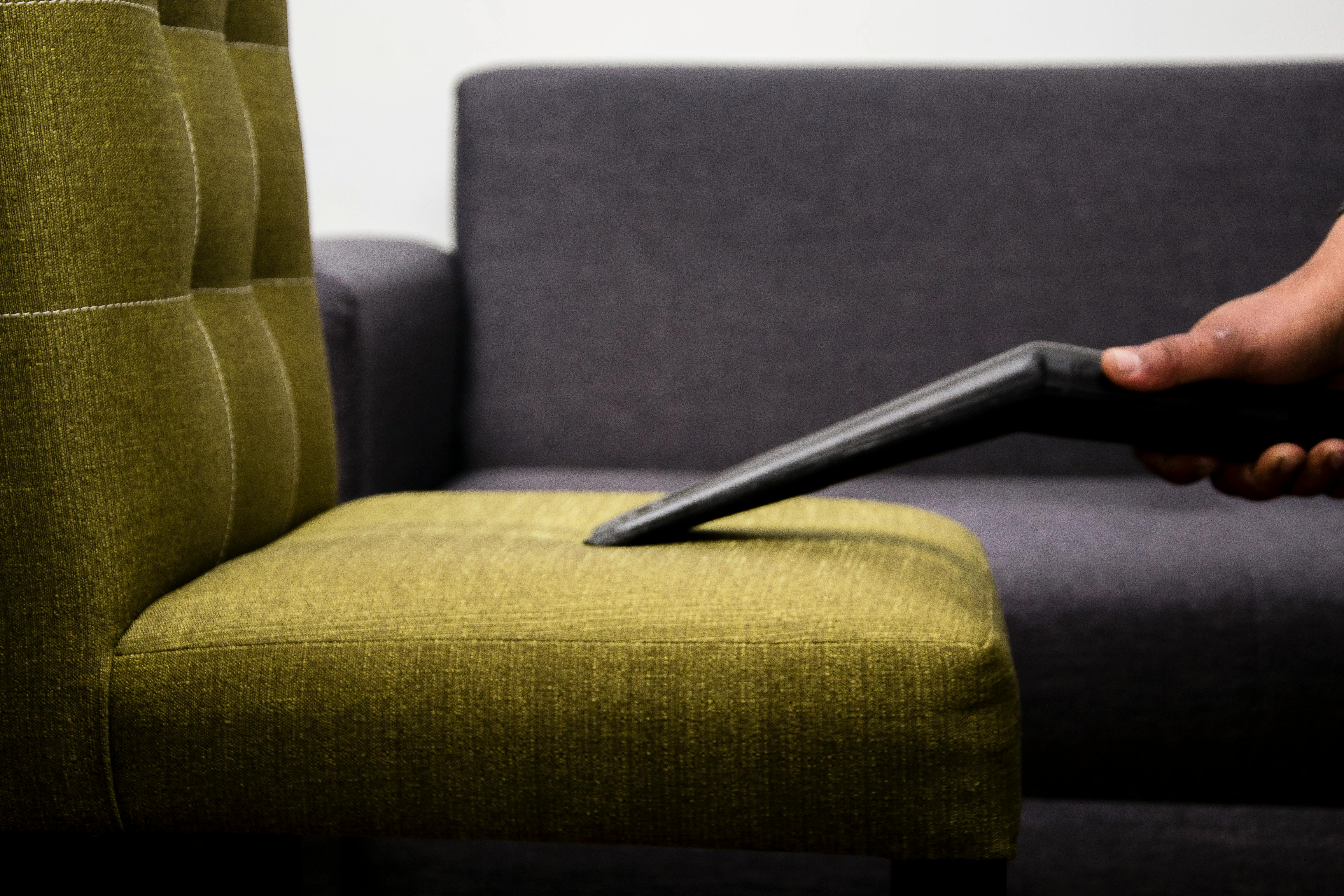 Vacuuming a couch | Source: Pexels