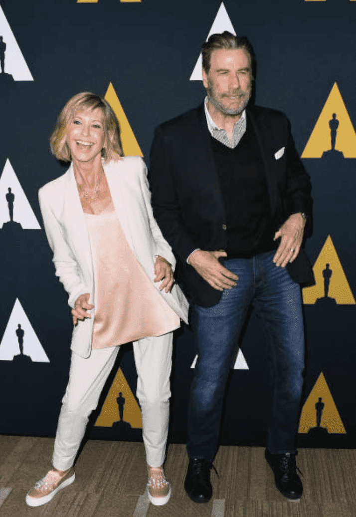Olivia Newton-John and John Travolta dance for cameras on the red carpet for the 40th Anniversary of "Grease," at Samuel Goldwyn Theater, on August 15, 2018 in Beverly Hills, California | Source: Getty Images (Photo by Jon Kopaloff/FilmMagic)