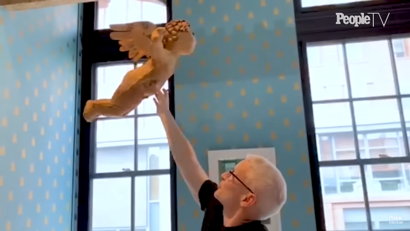 Anderson Cooper showing off a paper mache cupid in his son's nursery | Source: YouTube/PeopleTV