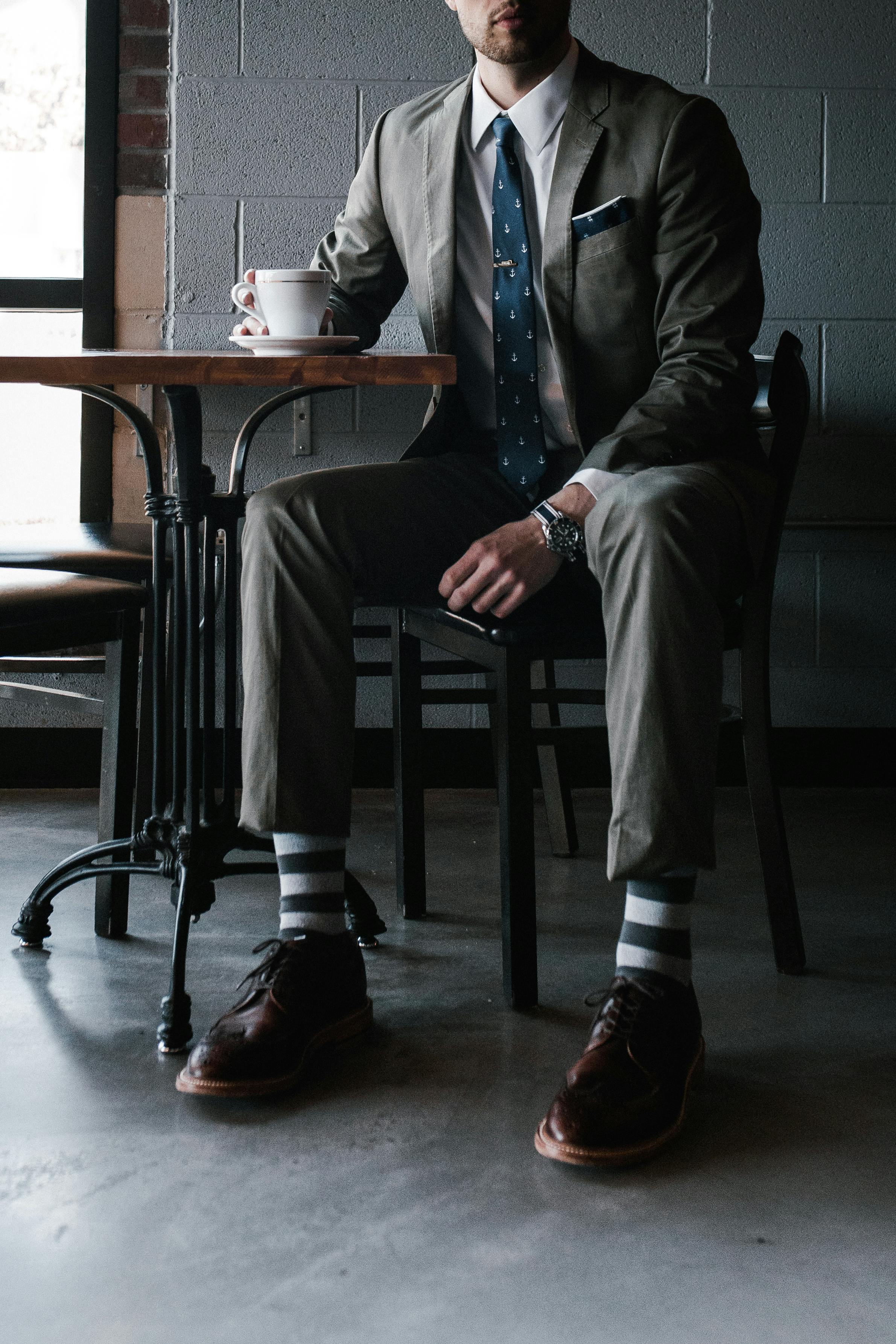 A man seated at a restaurant table | Source: Pexels