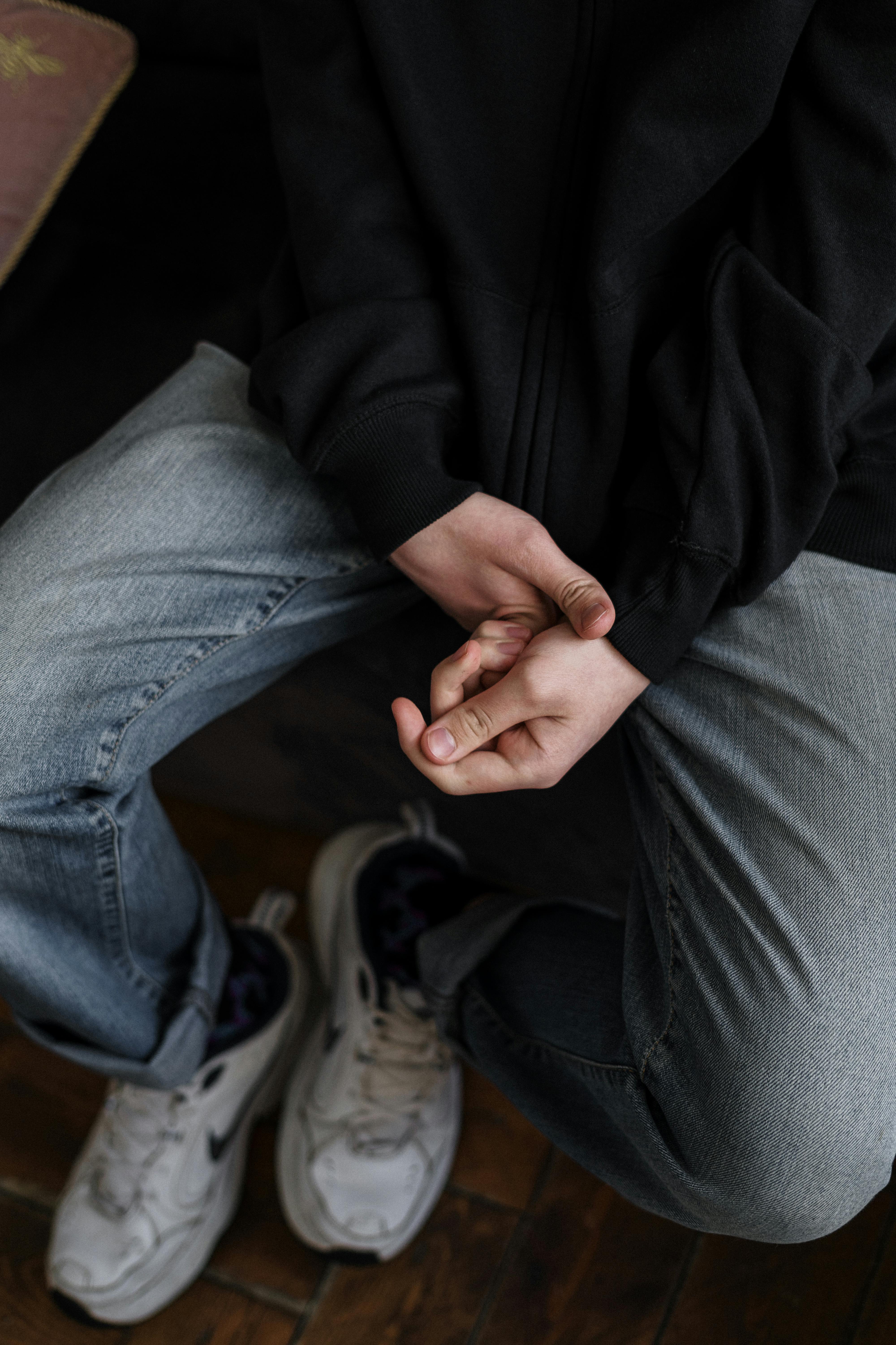 A teenage boy fiddling with his fingers and hands | Source: Pexels