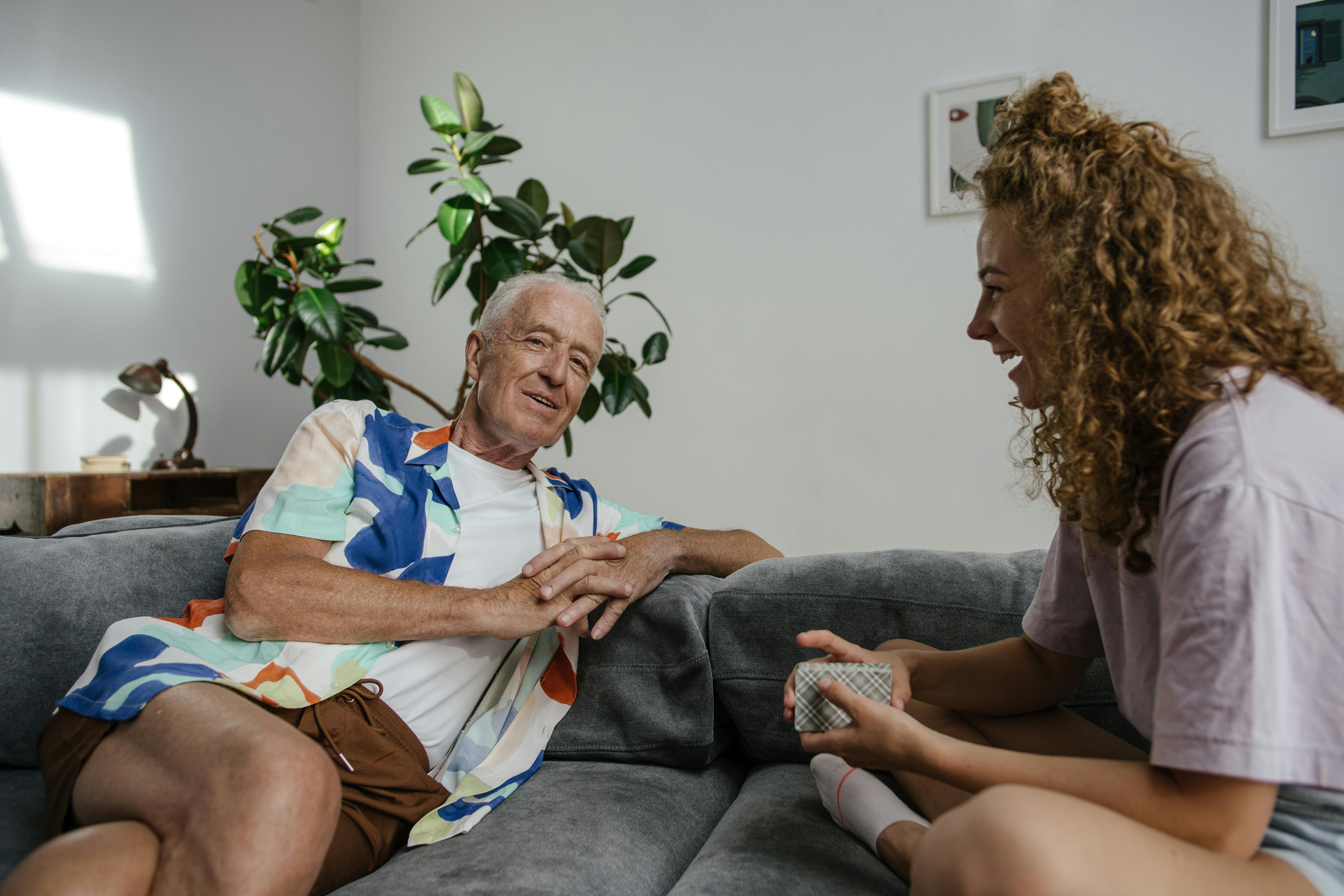 A smiling senior man and a young woman chatting | Source: Pexels