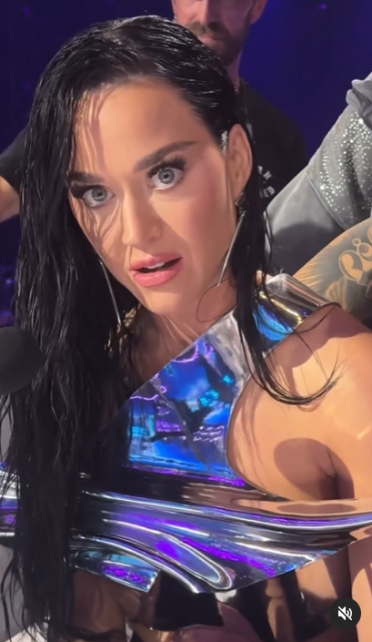 A screenshot shows Katy Perry's wide-eyed reaction to staff members fixing her stylish top." | Source: Instagram/katyperry