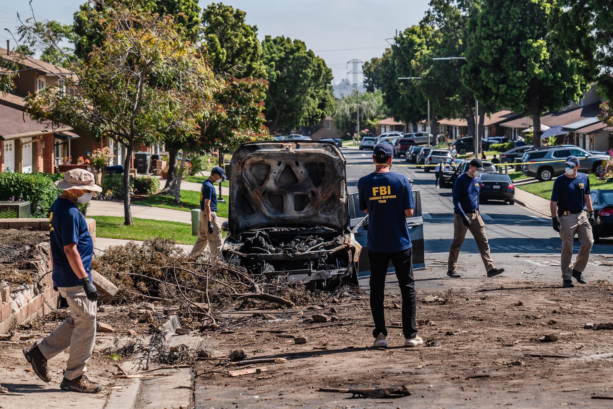 FBI personnel examine the scene where a Cessna 550 jet crashed into a residential area in San Diego’s Murphy Canyon neighborhood on May 22, 2025 | Source: Getty Images