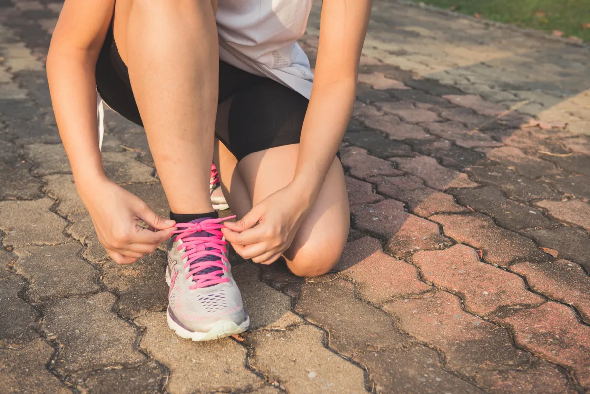 A woman tying their shoes | Source: Pexels