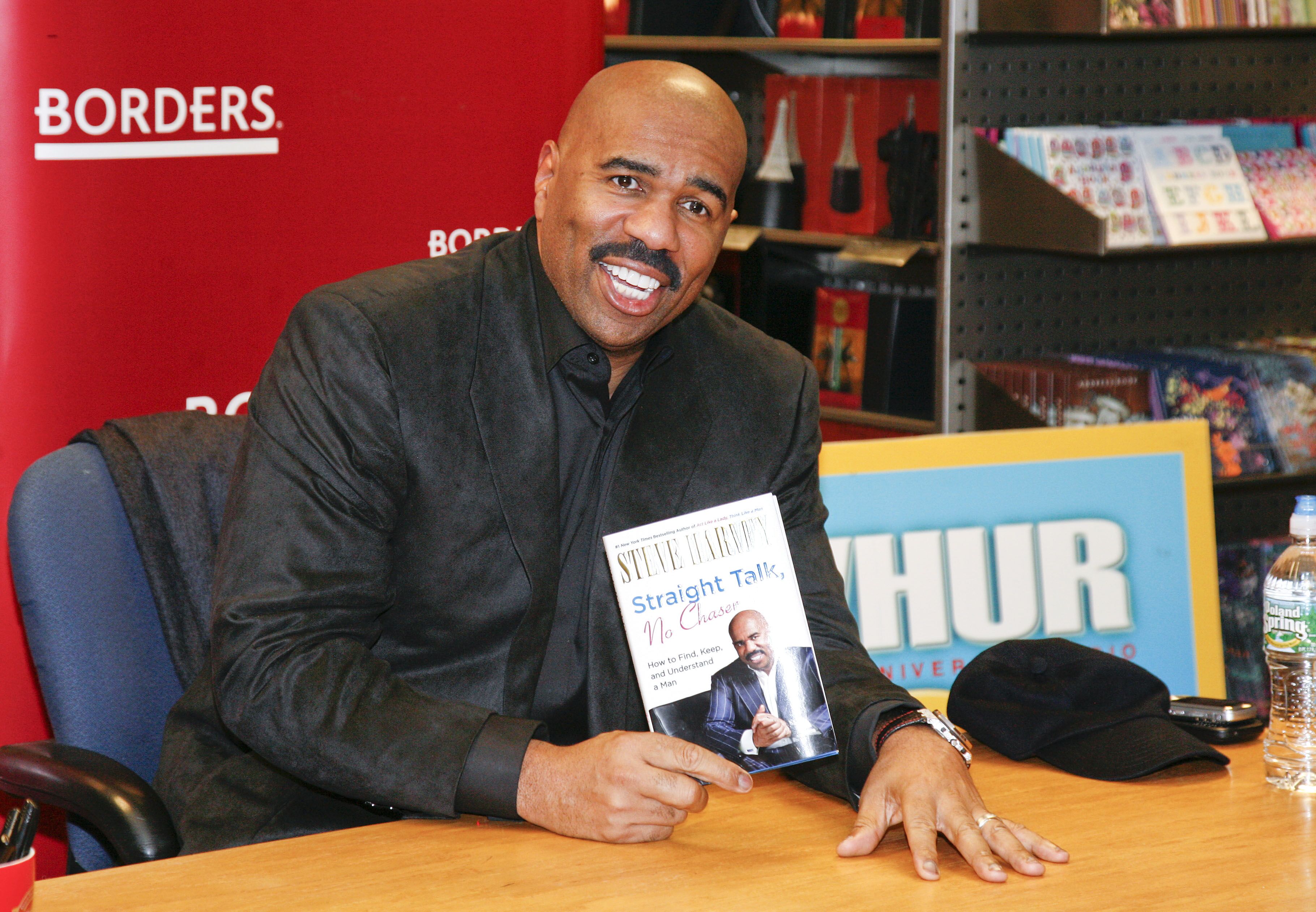 Steve Harvey signs copies of his book "Straight Talk, No Chaser" in Washington in 2011 | Source: Getty Images