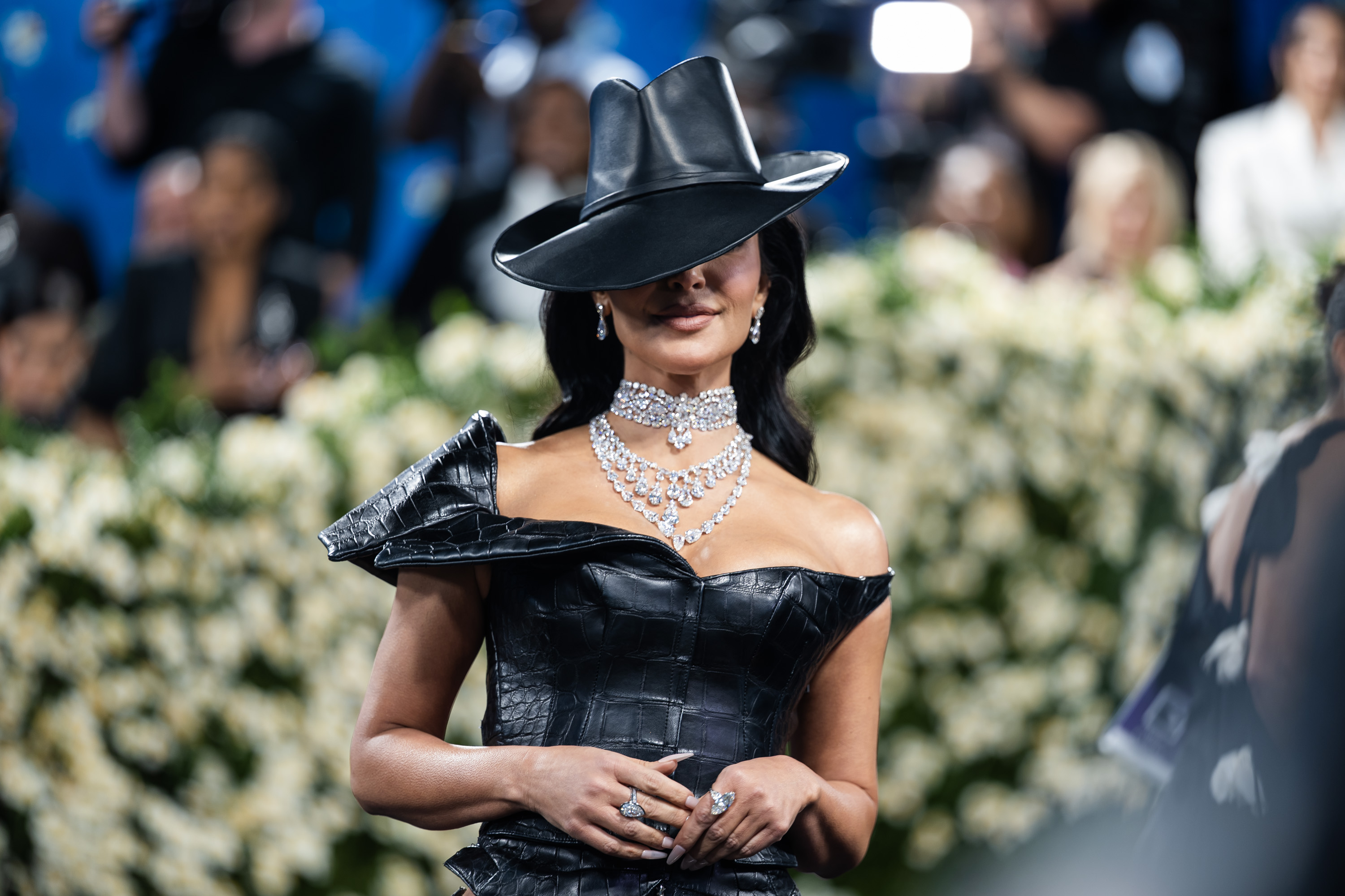 Kim Kardashian smiling in her wide-brimmed hat. | Source: Getty Images