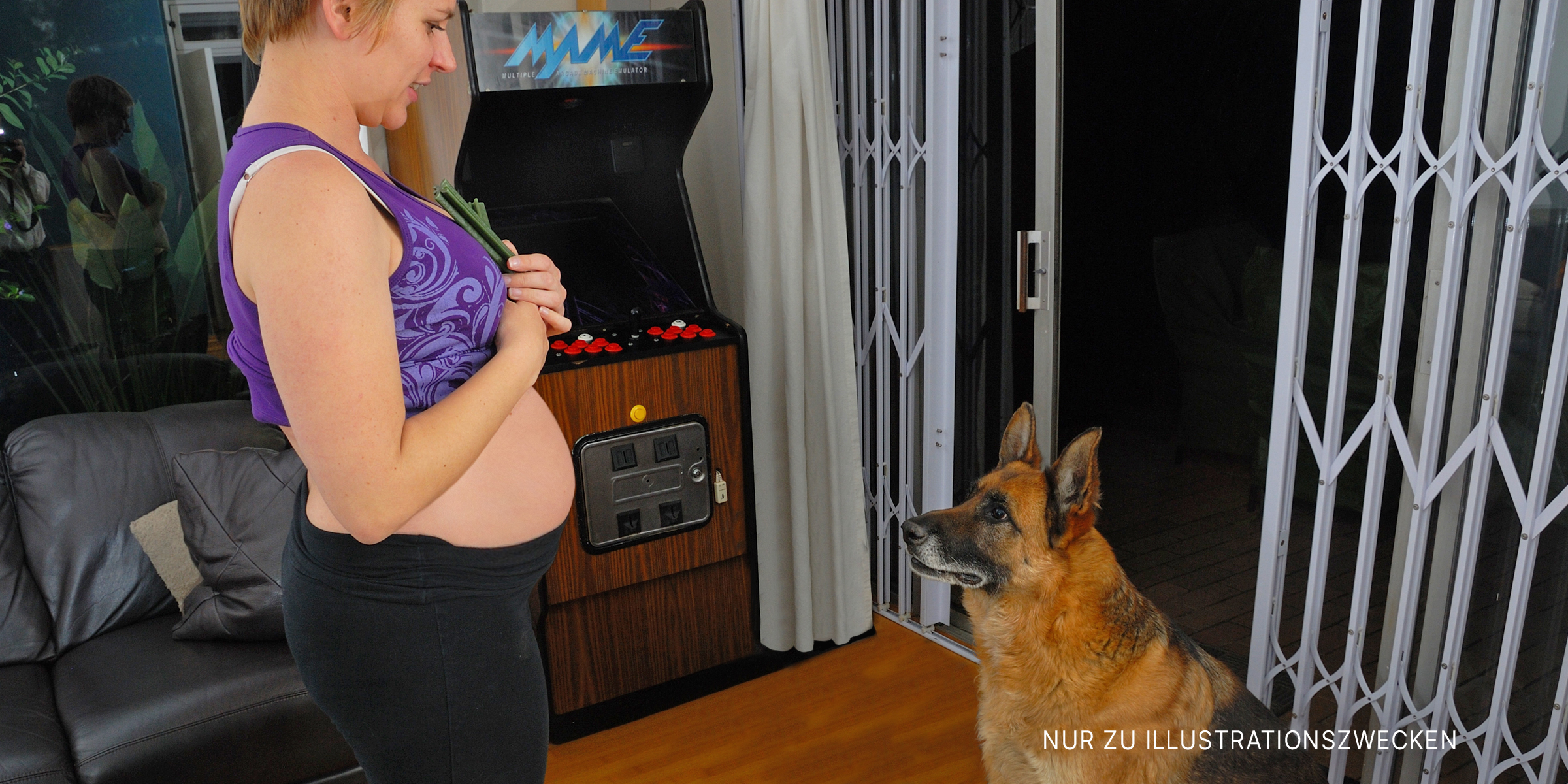 Ein Deutscher Schäferhund blickt zu einer schwangeren Frau auf | Quelle: Flickr / Locutis (CC BY-SA 2.0)
