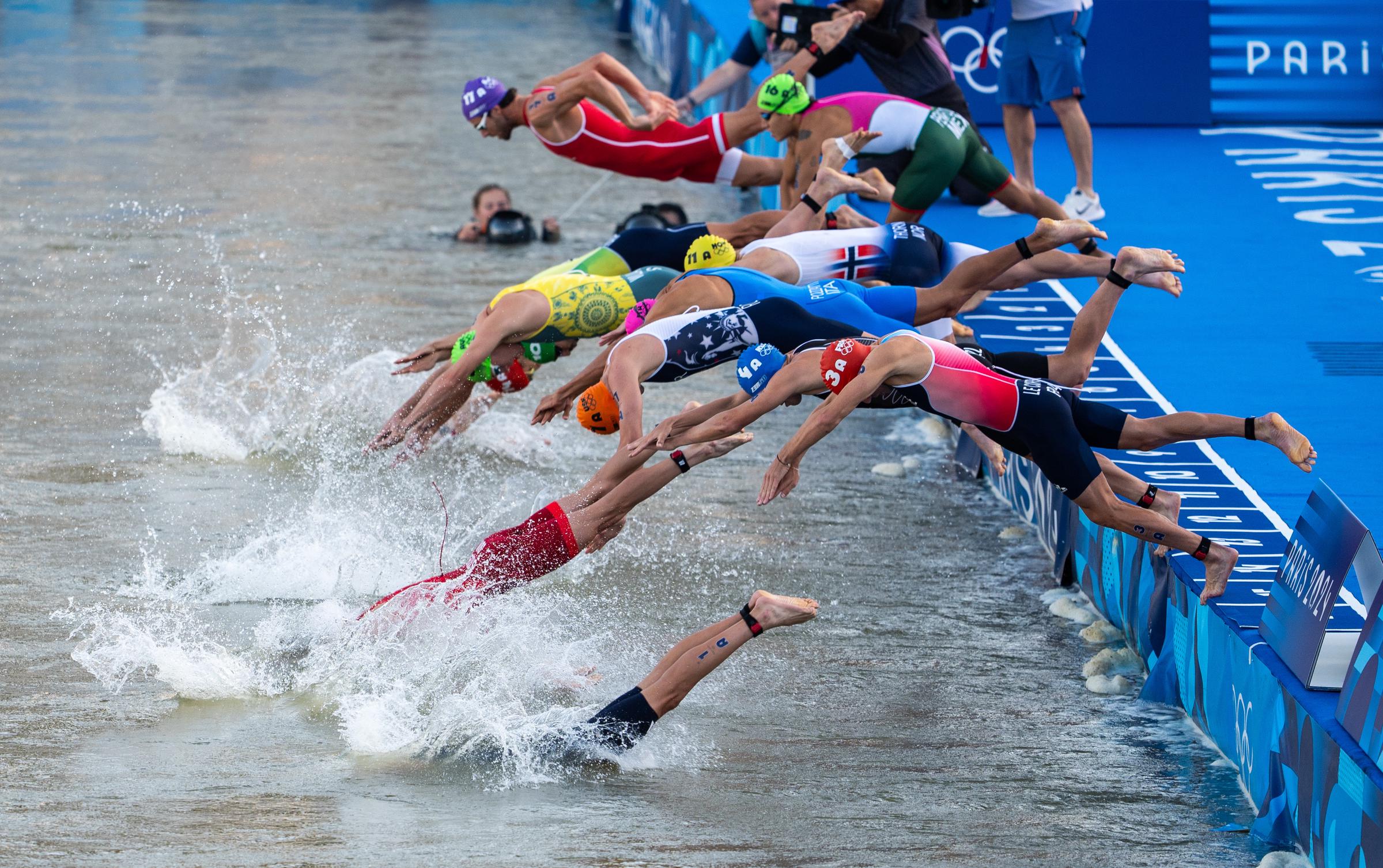 Athletes dive into the Seine River to compete in the Mixed Relay at the 2024 Olympic Games in Paris, France, on August 5, 2024 | Source: Getty Images