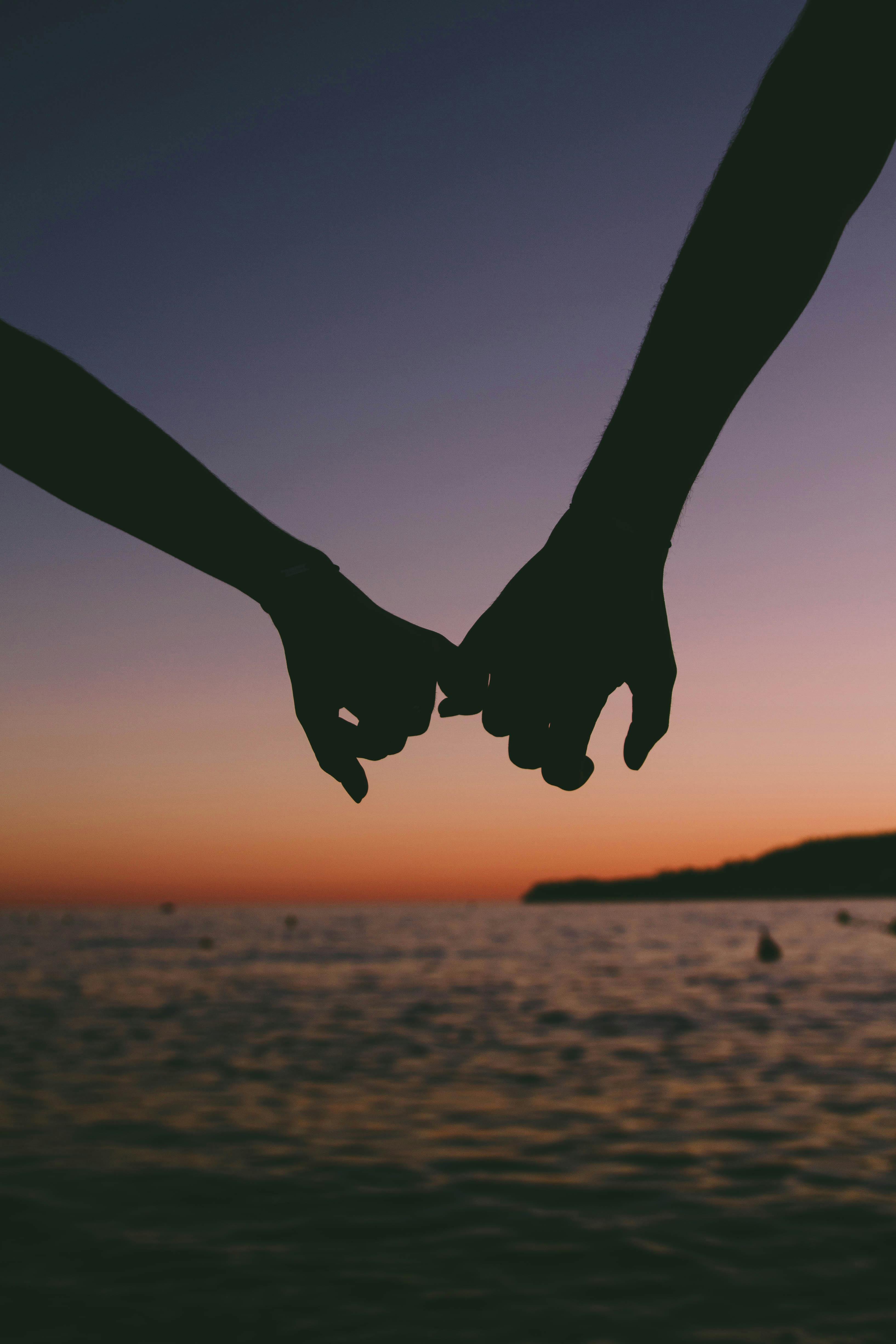 Holding hands on a ship | Source: Pexels