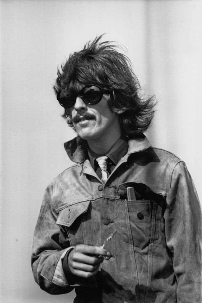 English guitarist, singer and songwriter George Harrison (1943 - 2001) of the Beatles at London Airport, UK | Getty Images / Global Images Ukraine English guitarist, singer and songwriter George Harrison (1943 - 2001) of the Beatles at London Airport, UK | Getty Images / Global Images Ukraine