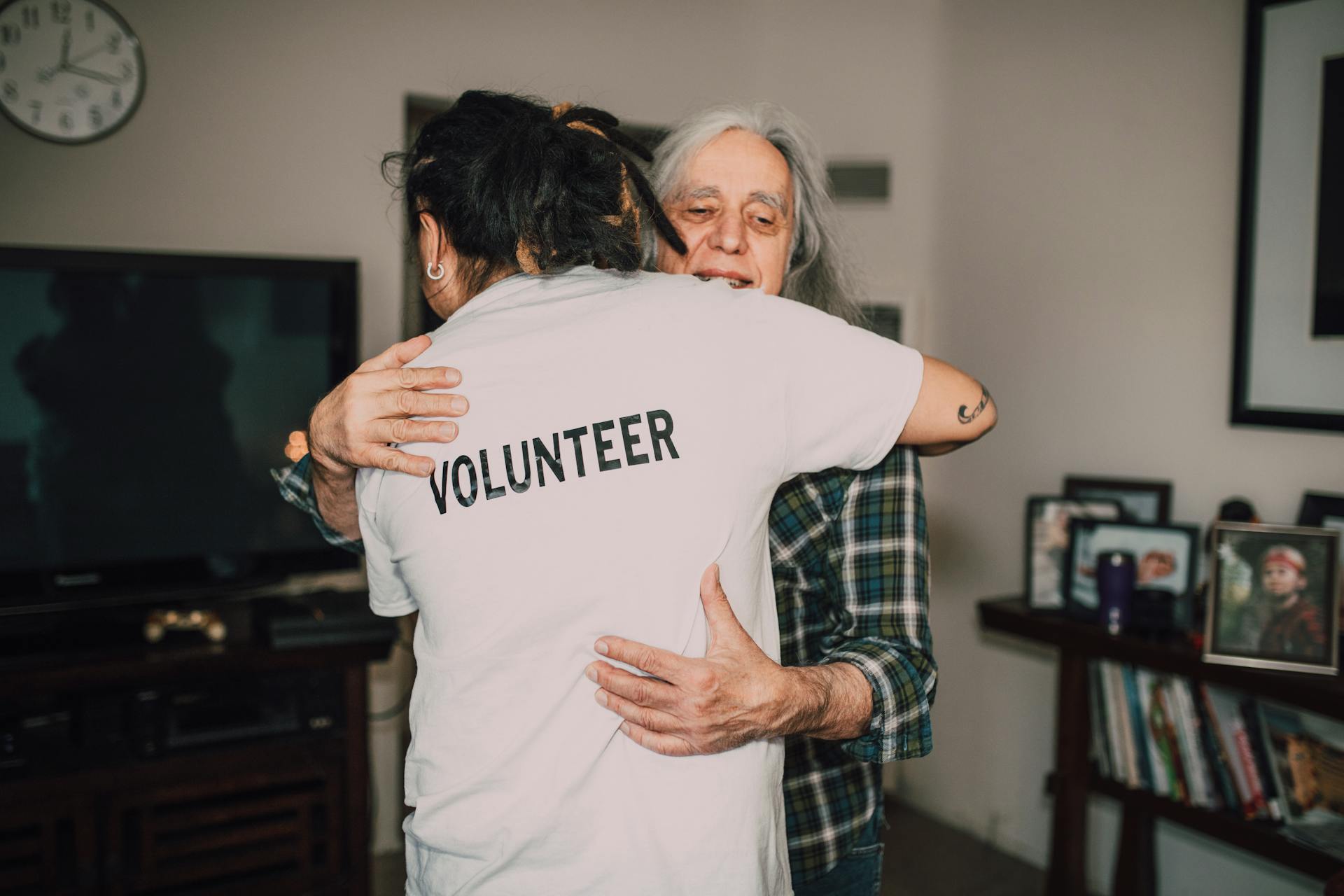 A volunteer hugging a senior citizen | Source: Pexels