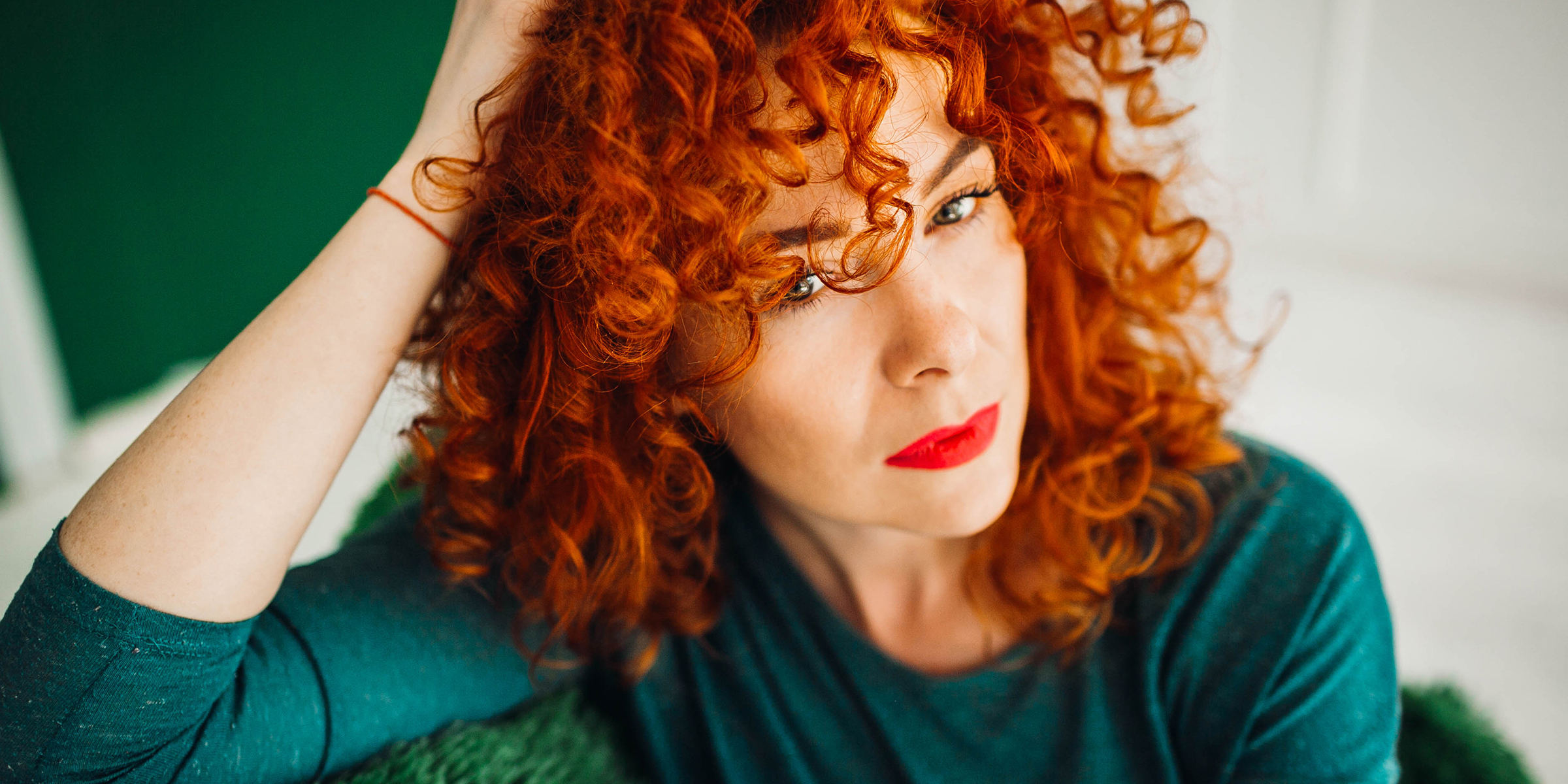 A woman with red hair and lipstick | Source: Freepik